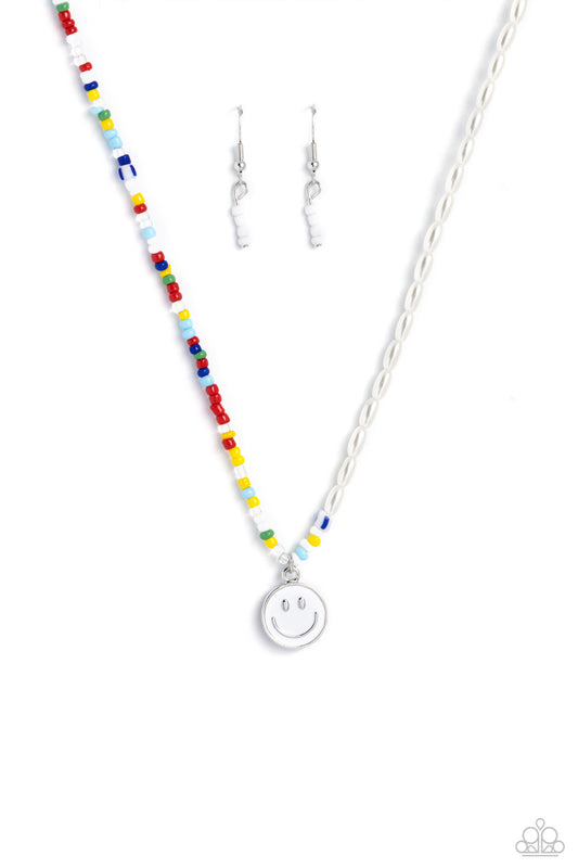 Paparazzi Accessories Smiling Showdown - White A strand of gleaming half pearl beads combines with seed beads in colorful shades for a youthful design along the collar. A white smiley face disc hangs from the colorfully classic display for additional char