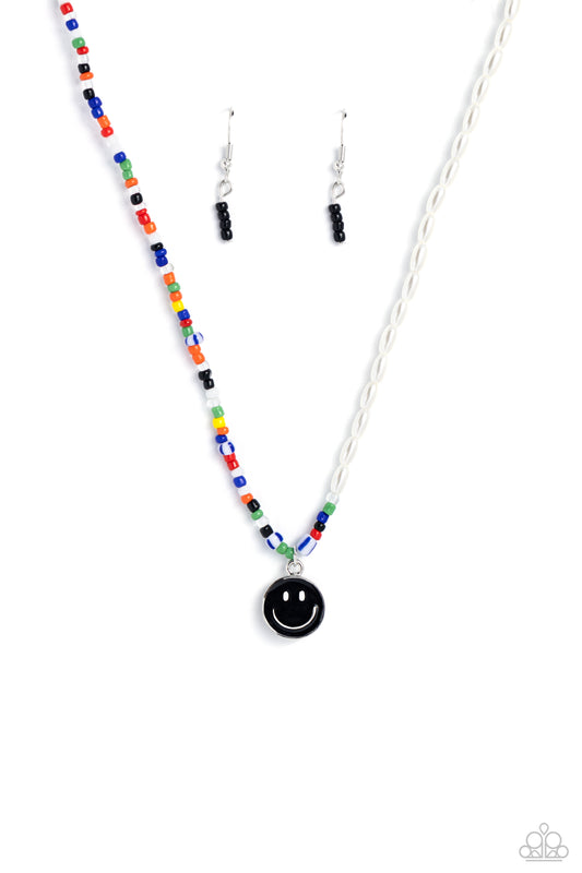 Paparazzi Accessories Smiling Showdown - Black A strand of gleaming half pearl beads combines with seed beads in colorful shades for a youthful design along the collar. A black smiley face disc hangs from the colorfully classic display for additional char