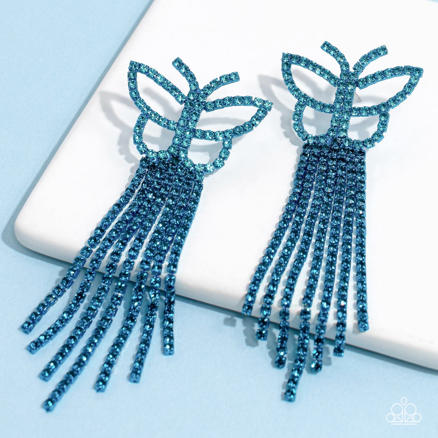 Paparazzi Accessories Billowing Butterflies - Blue Glassy blue rhinestones, encrusted along the front of a blue butterfly frame, create a whimsical centerpiece. Staggered rows of different blue rhinestones pressed in delicate blue square fittings cascade