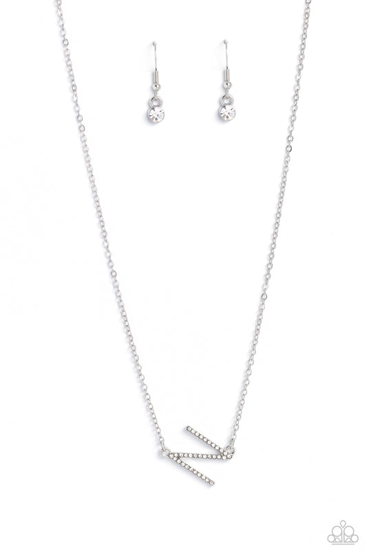 Paparazzi Accessories INITIALLY Yours - N - White Embossed with dainty white rhinestones, a silver letter "N" hovers below the collar from a dainty silver chain, for a sentimentally simple design. Features an adjustable clasp closure. Sold as one individu