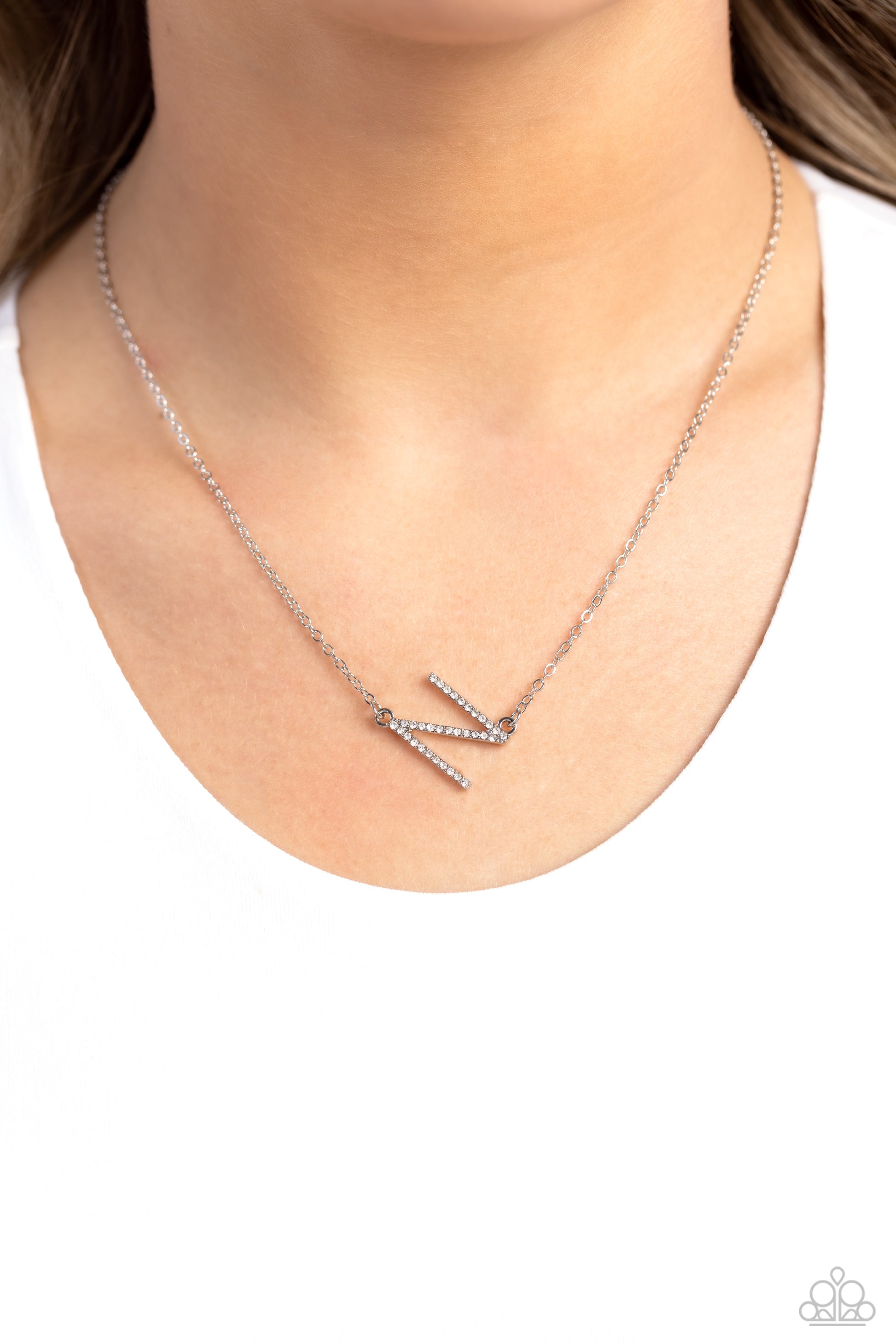 Paparazzi Accessories INITIALLY Yours - N - White Embossed with dainty white rhinestones, a silver letter "N" hovers below the collar from a dainty silver chain, for a sentimentally simple design. Features an adjustable clasp closure. Sold as one individu