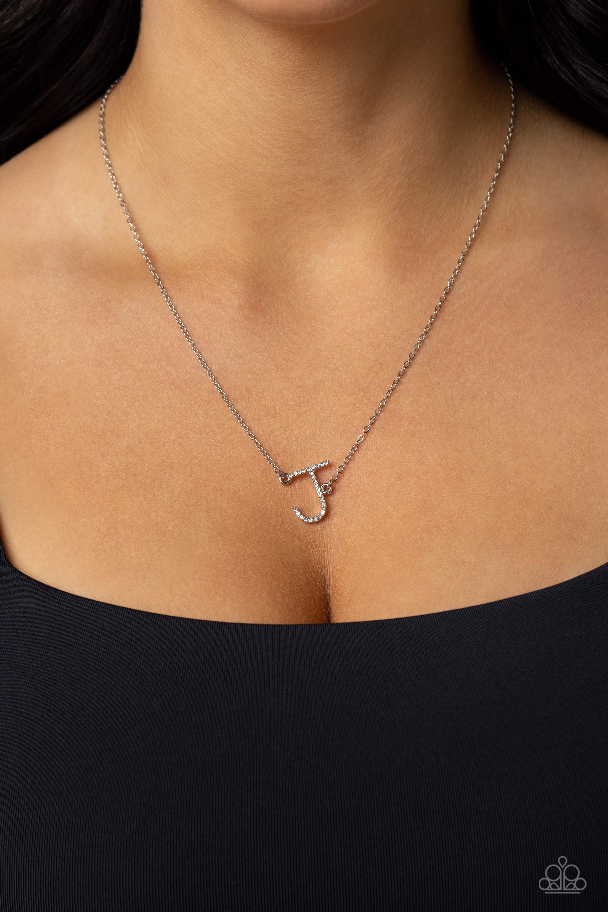 Paparazzi Accessories INITIALLY Yours - J - White Embossed with dainty white rhinestones, a silver letter "J" hovers below the collar from a dainty silver chain, for a sentimentally simple design. Features an adjustable clasp closure. Sold as one individu