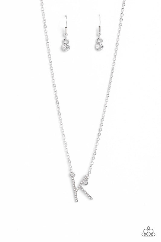 Paparazzi Accessories INITIALLY Yours - K - White Embossed with dainty white rhinestones, a silver letter "K" hovers below the collar from a dainty silver chain, for a sentimentally simple design. Features an adjustable clasp closure. Sold as one individu
