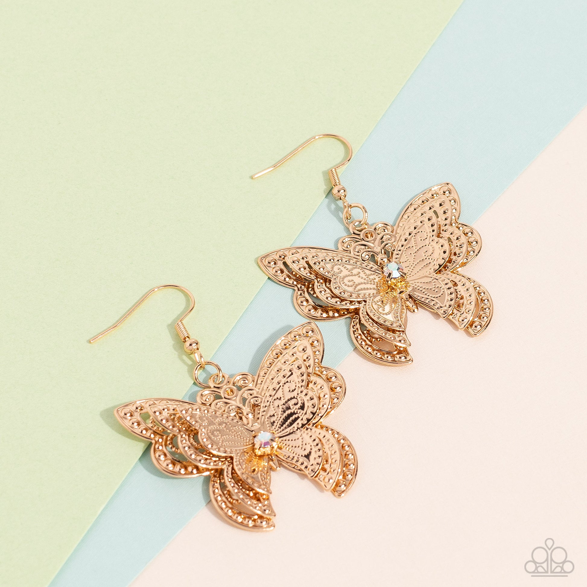 Paparazzi Accessories Layered Launch - Multi A whimsical 3D butterfly, with ornate details and textures, elegantly increases in size to create a three-layered high-sheen gold lure. An iridescent gem is nestled at the center of the butterfly's wings, creat