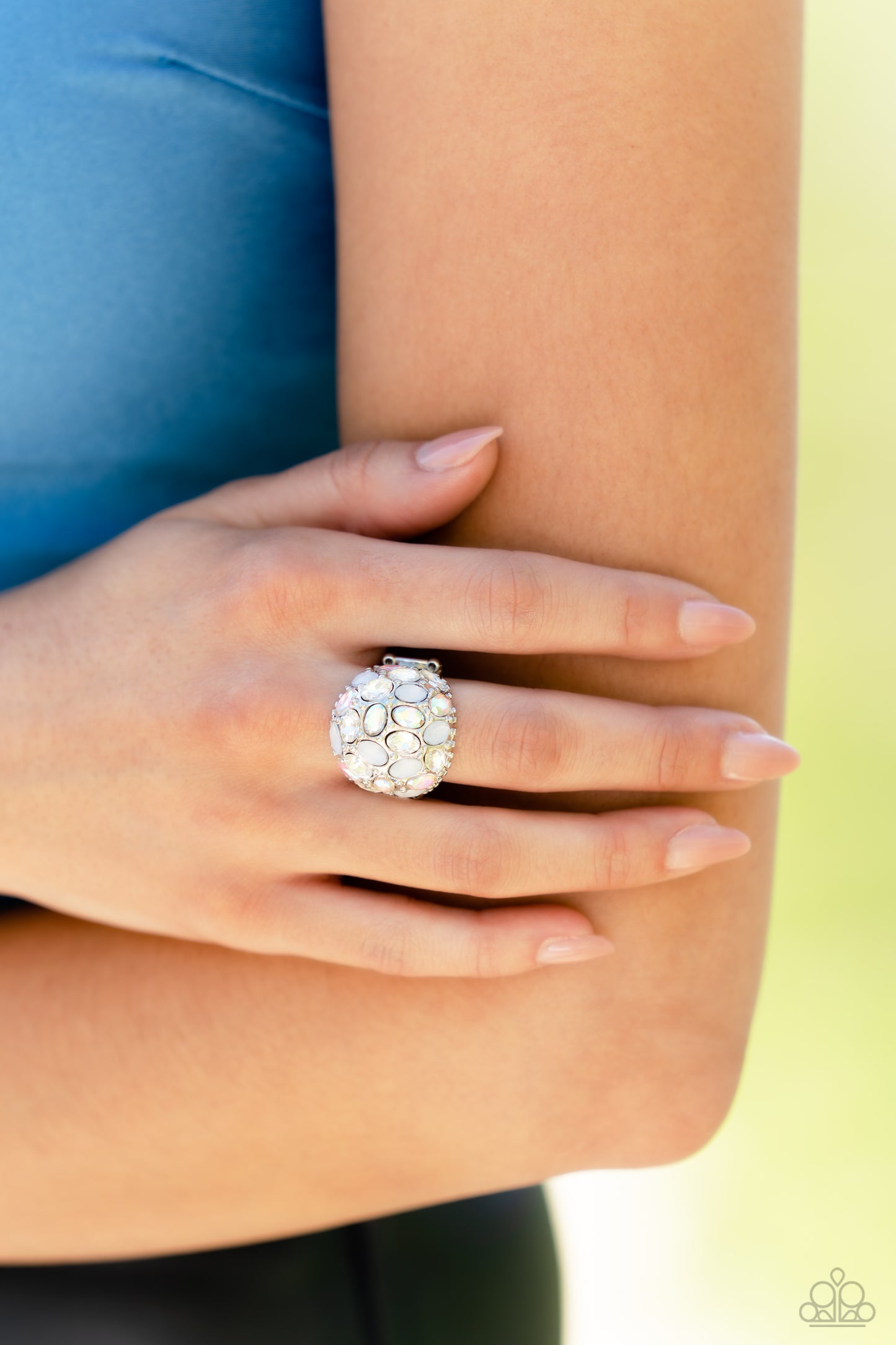 Paparazzi Accessories BLING Loud and Proud - White A studded silver frame, filled with blinding oval-cut gems in opalescent, white, and iridescent shades, stands out atop the finger for a blingy statement. Features a stretchy band for a flexible fit. Due