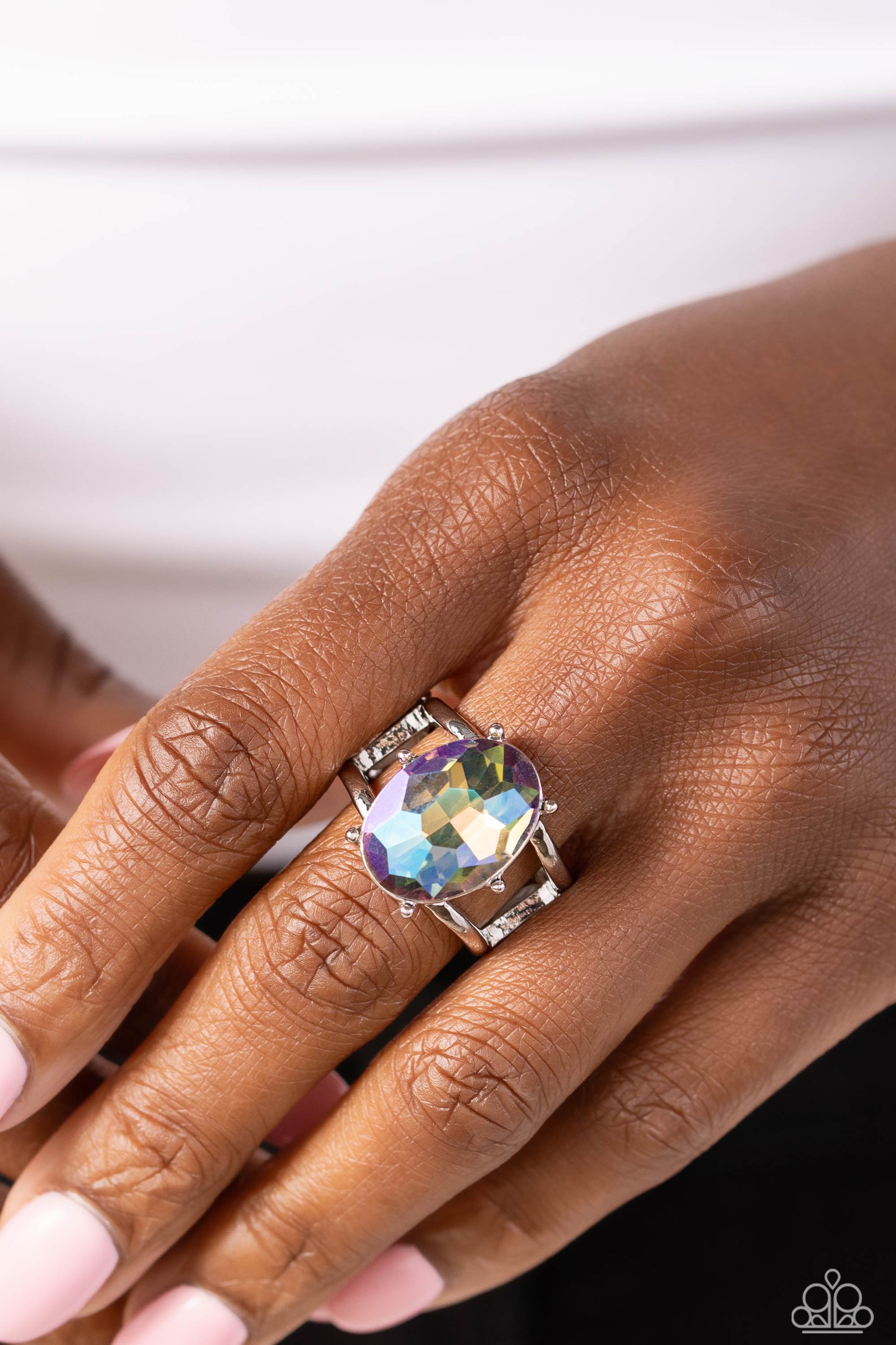 Paparazzi Accessories Prismatically Pronged - Multi Silver pronged fittings coalesce around an oval gem splashed in a prismatic UV shimmer atop the center of an airy silver band, resulting in a refined centerpiece atop the finger. Features a stretchy band