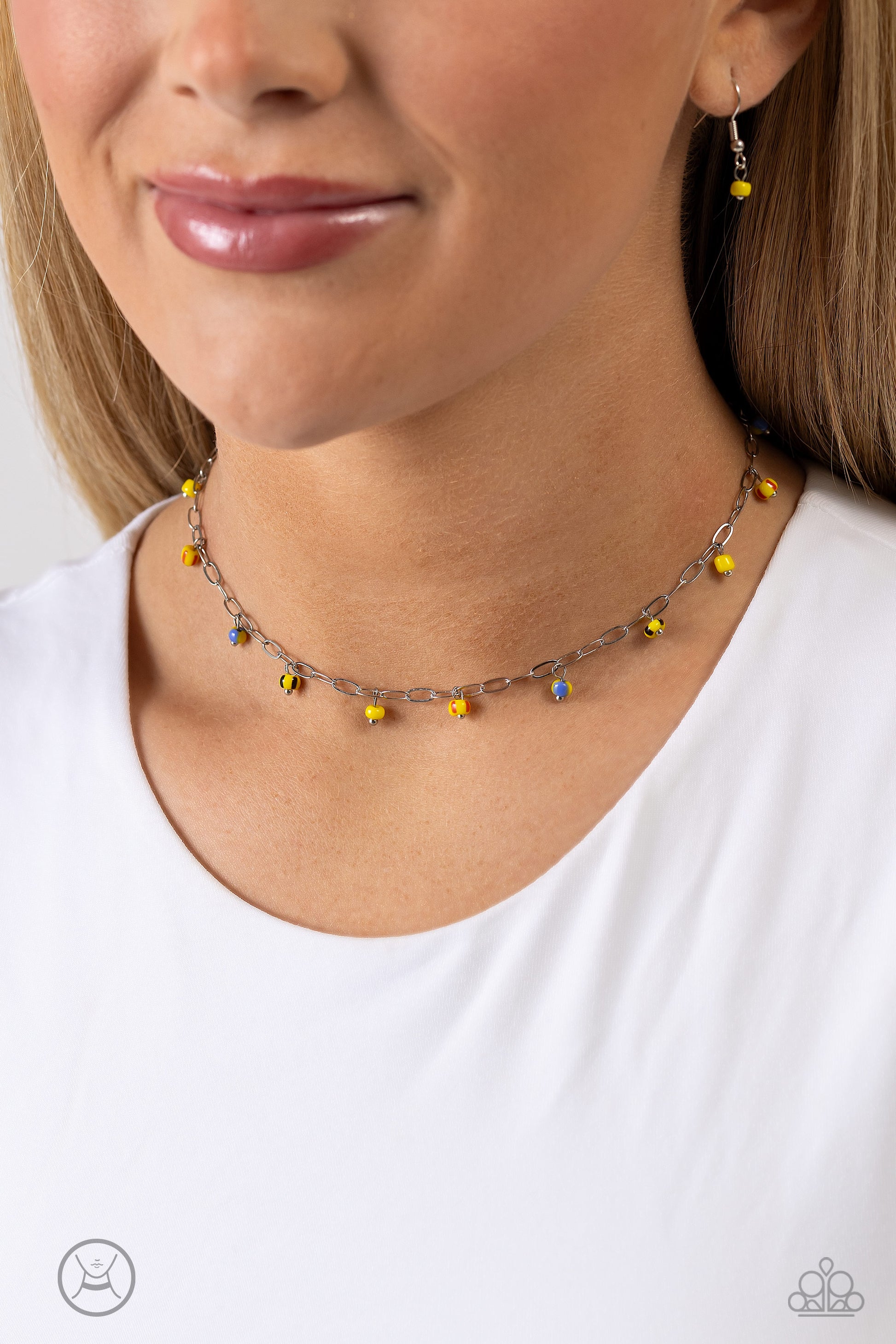 Paparazzi Accessories Beach Ball Bliss - Yellow Featuring multicolored spots, bright yellow seed beads dangle along a single dainty silver link chain for a beachy flair. Features an adjustable clasp closure. Sold as one individual choker necklace. Include
