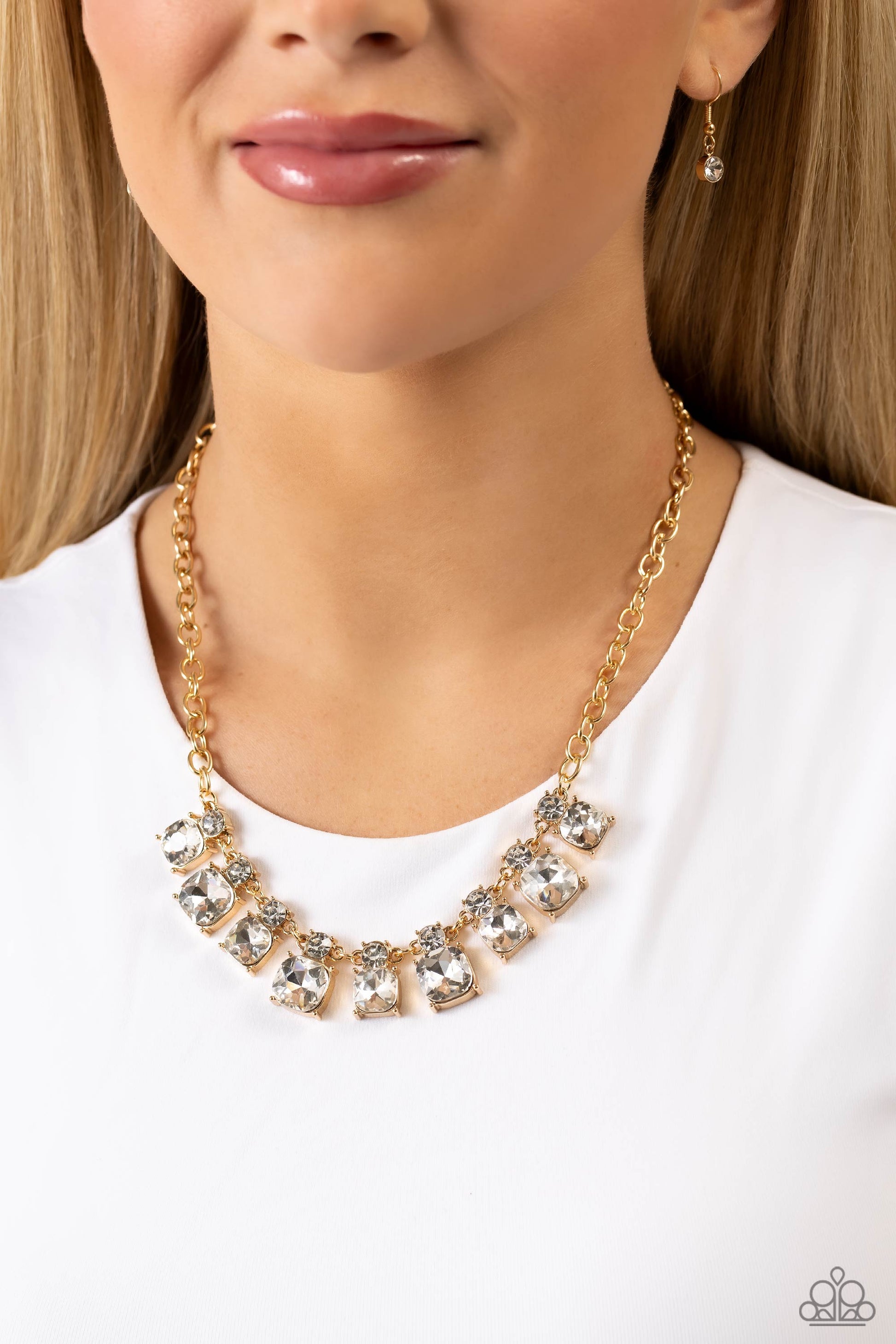 Paparazzi Accessories Fitted Fantasy - Gold Infused along a gold link chain, faceted white gems, in thick gold fittings, alternate in size below the collar. Dainty white gems kiss the tops of the bigger gems for additional light-catching shimmer and shine