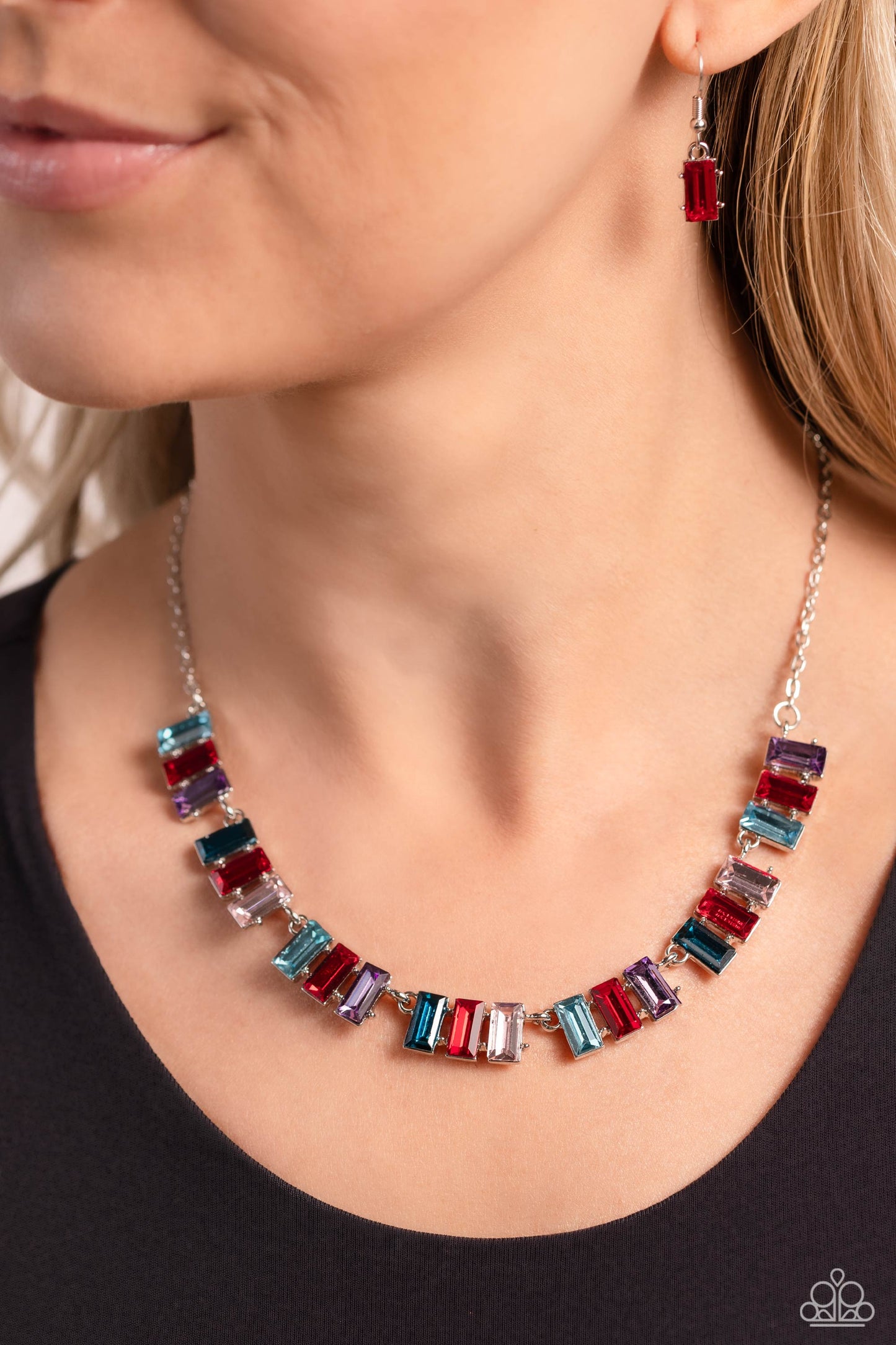 Paparazzi Accessories Elite Emeralds - Red Featuring pronged frames of three, emerald-cut bars splashed in glassy blue, red, purple, and pink hues collect along a dainty silver chain down the neckline for a refined pop of color. Features an adjustable cla