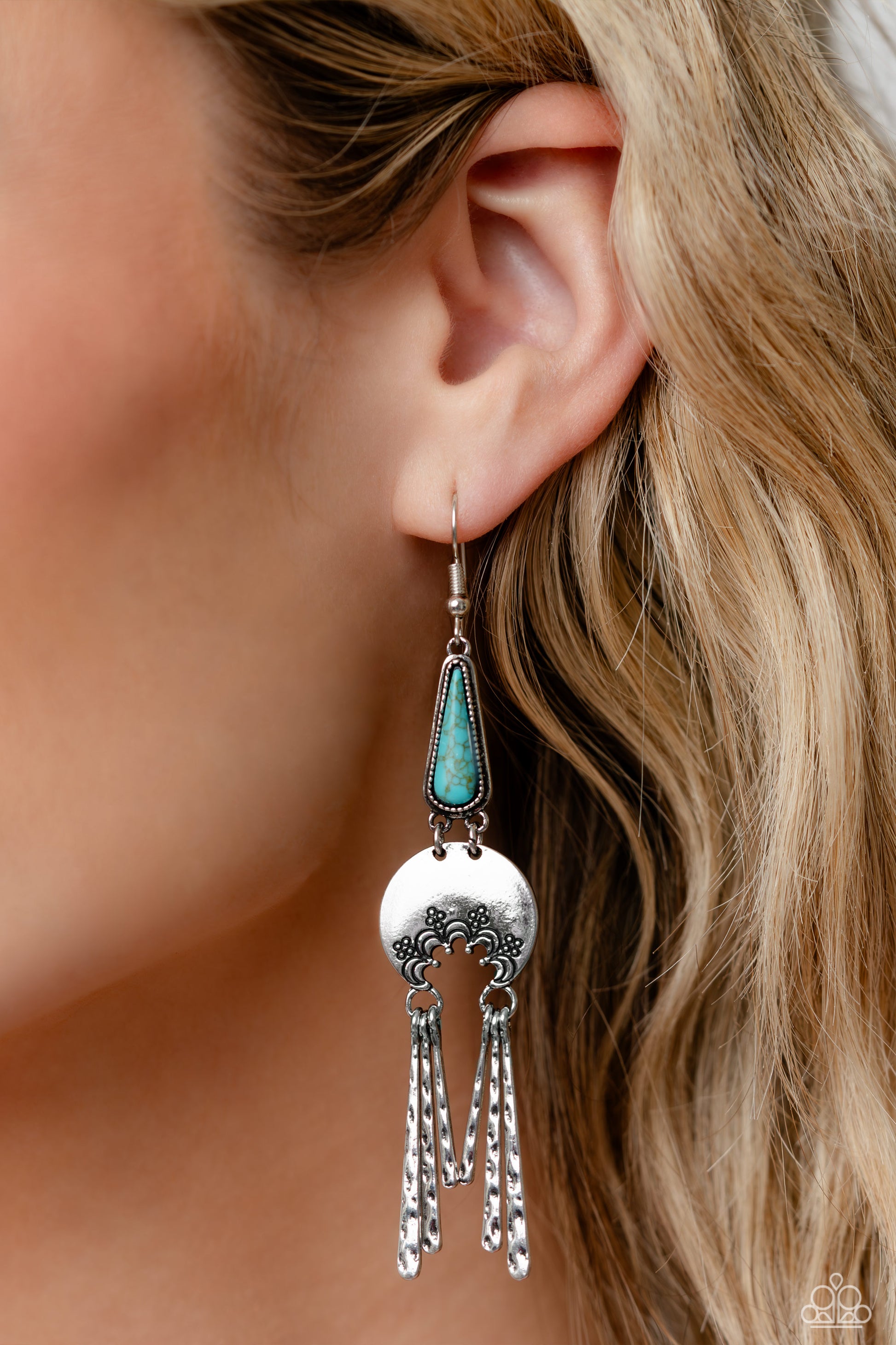 Paparazzi Accessories Highland Haute - Blue A turquoise stone pressed in a studded triangular fitting, and a silver floral-decorated half moon frame link into an earthy lure. A collection of daintily textured silver tassels in varying sizes swing from the