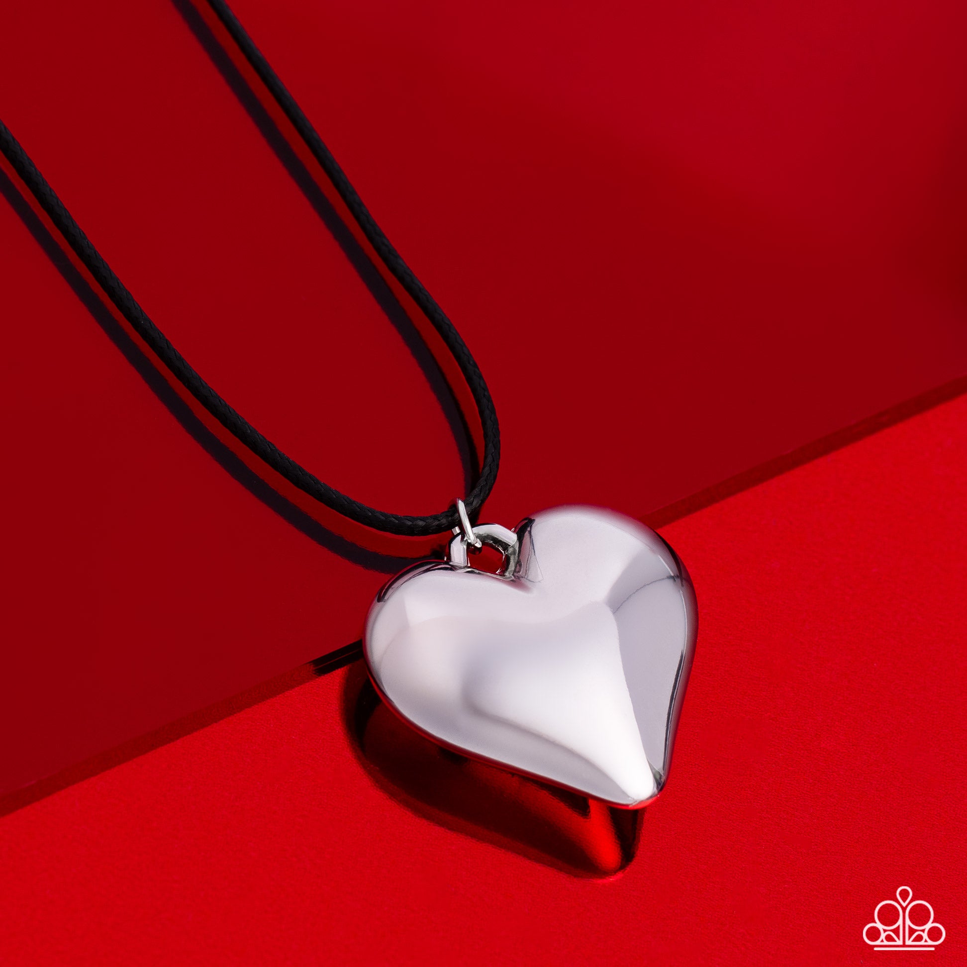 Paparazzi Accessories CORDED Love - Black Brushed in a high-sheen finish, an oversized silver heart pendant swings from the bottom of a skinny black leather cord, creating a rustically romantic statement. Features an adjustable clasp closure. Sold as one