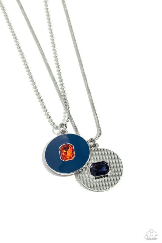 Paparazzi Accessories Cryptic Couture - Blue Two various dainty silver chains, one a snake and the other a ball, delicately layer below the collar. A navy-painted pendant with a dainty emerald-cut orange gem center sparkles at the bottom of the uppermost