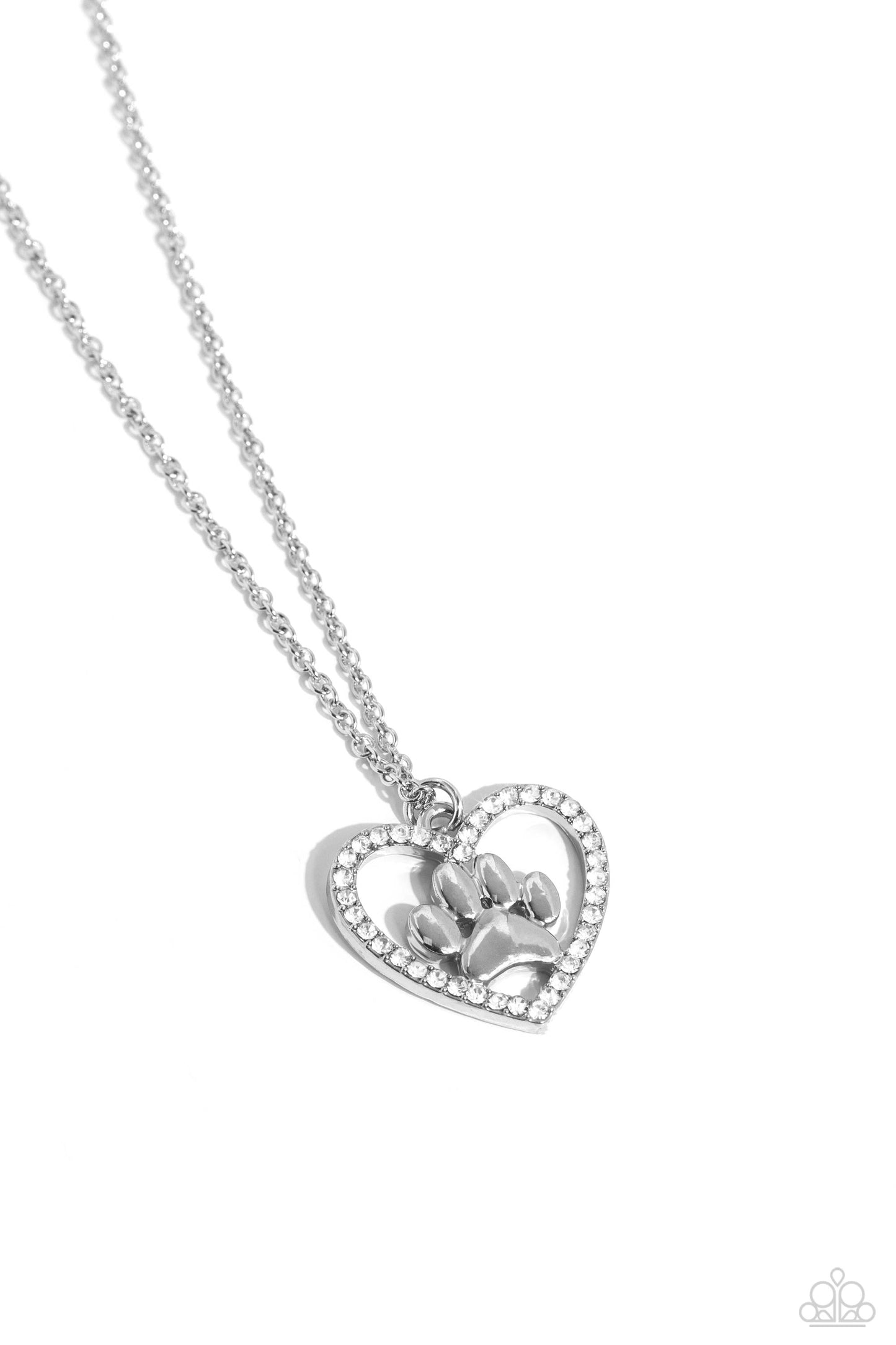 Paparazzi Accessories PET in Motion - White Featuring a paw print charm, an airy rhinestone-embossed heart frame glides down the neckline on a dainty, classic silver chain for a pet-lover inspired pendant. Features an adjustable clasp closure. Sold as one