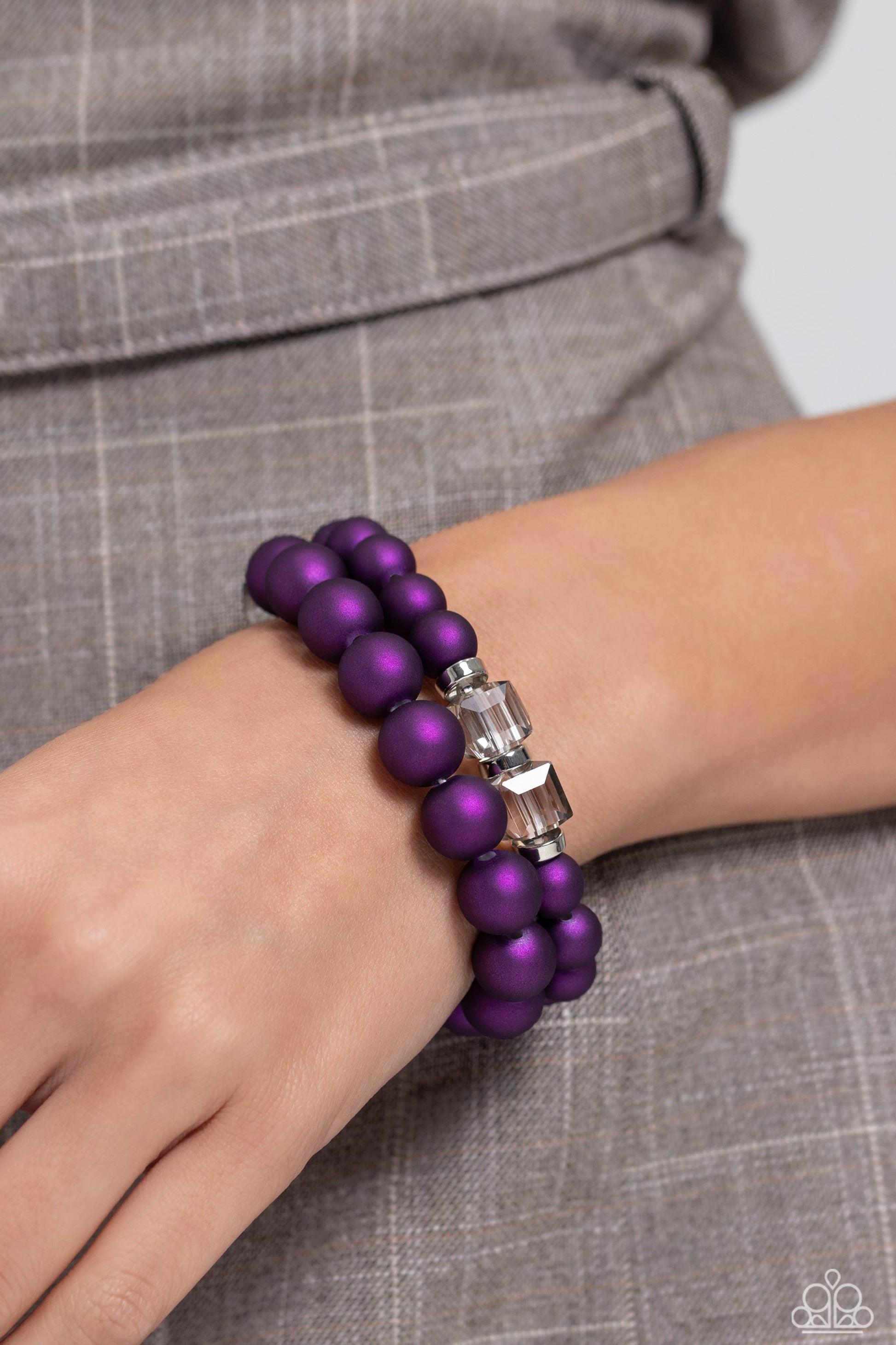 Paparazzi Accessories Shopaholic Showdown - Purple Two strands of oversized purple beads featuring a subtle shimmer, silver accents, and clear gray cubed beads stretch around the wrist, creating refined, colorful layers. Sold as one set of two bracelets.