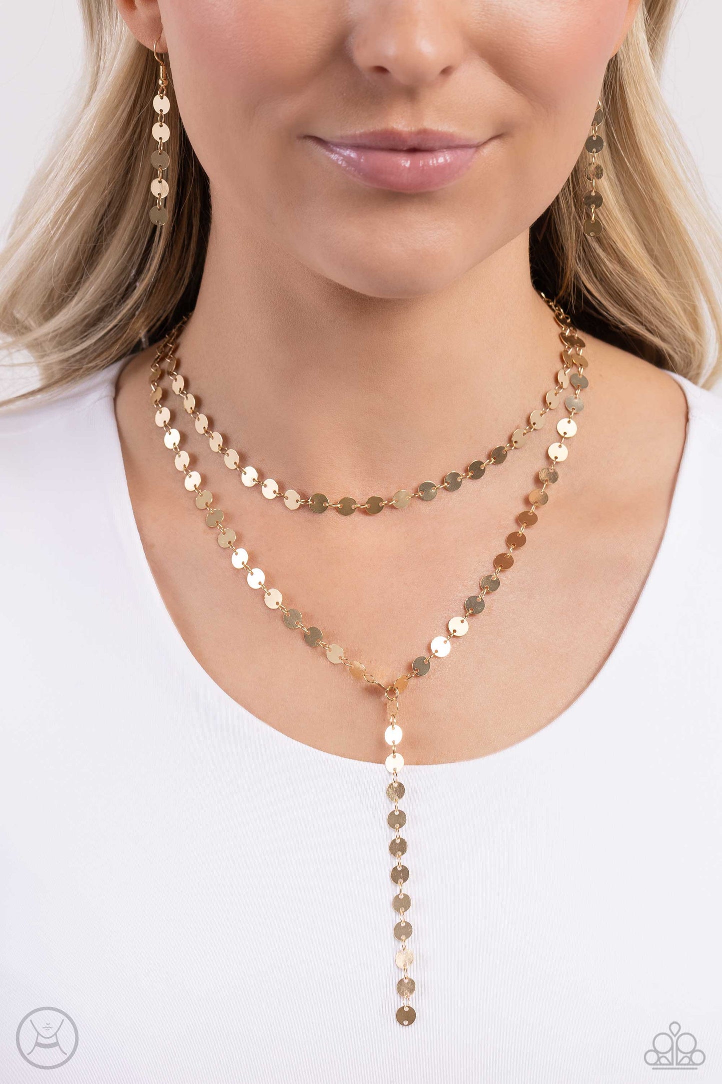 Paparazzi Accessories Reeling in Radiance - Gold High-sheen gold discs trickle around the collar and down the chest, creating an edgy lariat-styled fringe that sways and shimmers. Features an adjustable clasp closure. Sold as one individual choker necklac