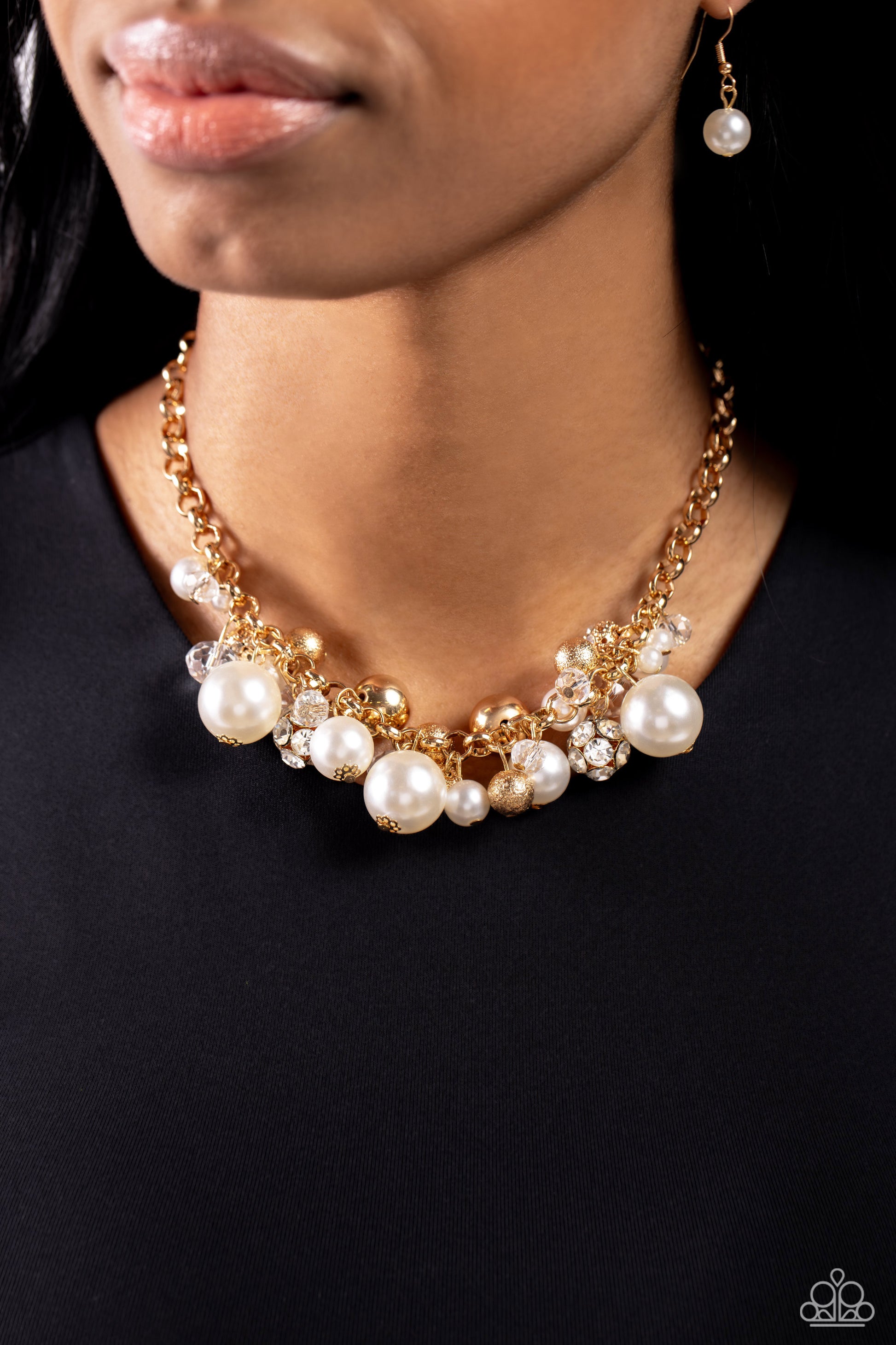 Paparazzi Accessories Corporate Catwalk - Gold A collection of bubbly white pearls, glittery crystal-like beads, gold beads, some embossed in shimmer, and gem-encrusted beads swing from the bottom of a chunky gold chain, creating an elegantly clustered fr