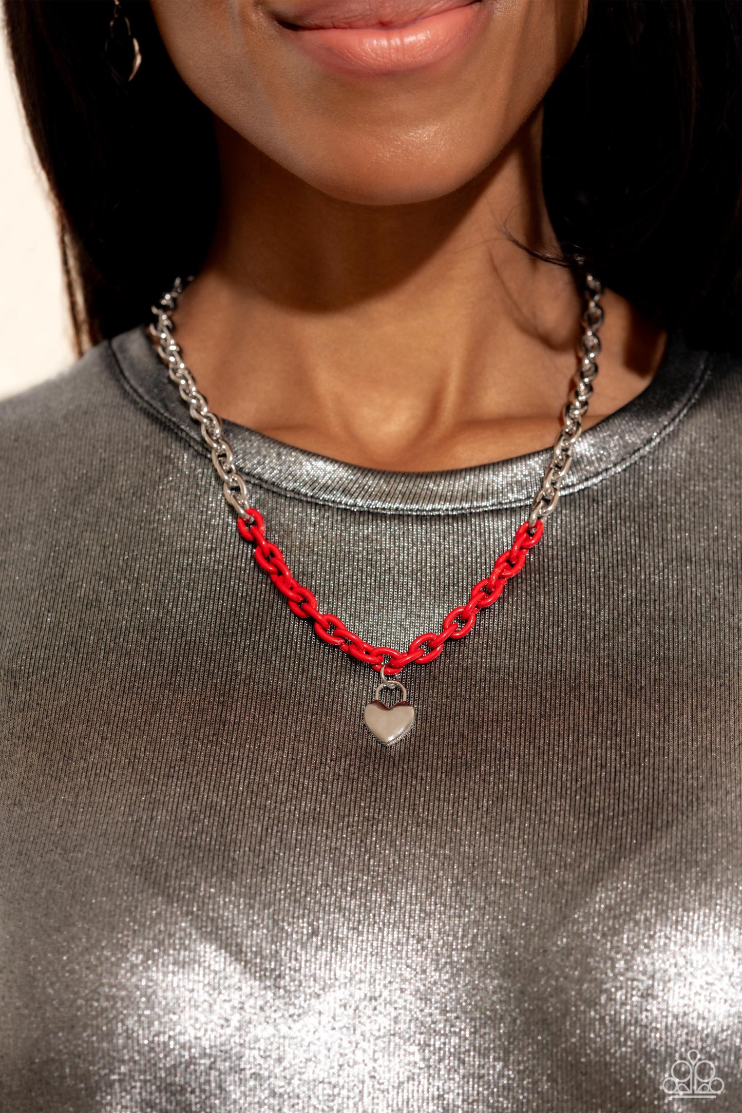 Paparazzi Accessories Locked Down - Red Infused with splashes of red chain, a lengthened oversized high-sheen silver chain dances down the chest for a spunky industrial statement. A dainty hammered silver lock pendant graces the bottom of the necklace, fu