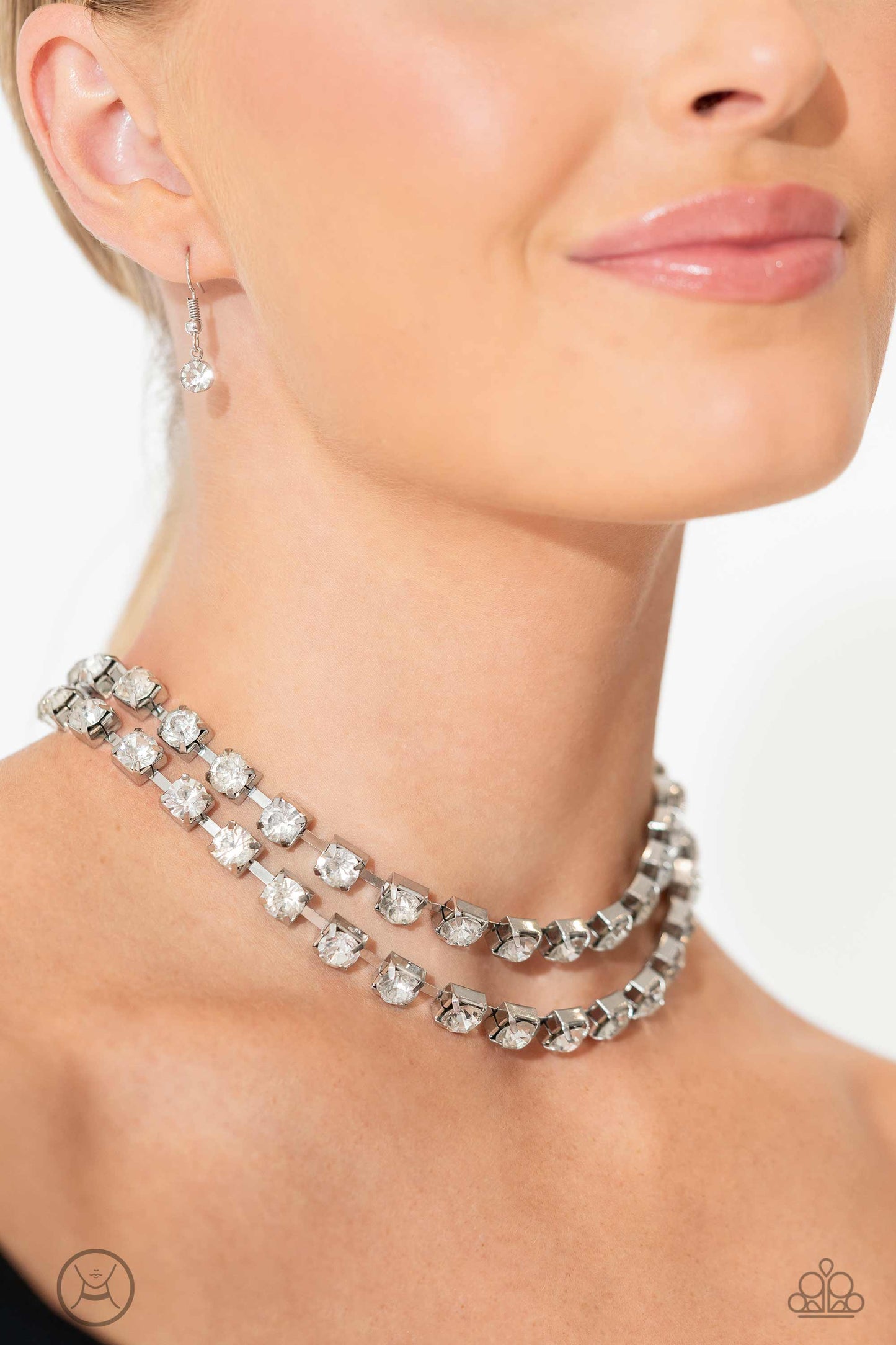 Paparazzi Accessories Glistening Gallery - White Featuring pronged silver fittings, strands of oversized, glittery white rhinestones connect with rows of silver box chains around the neck for a glittery twist. Features an adjustable clasp closure. Sold as