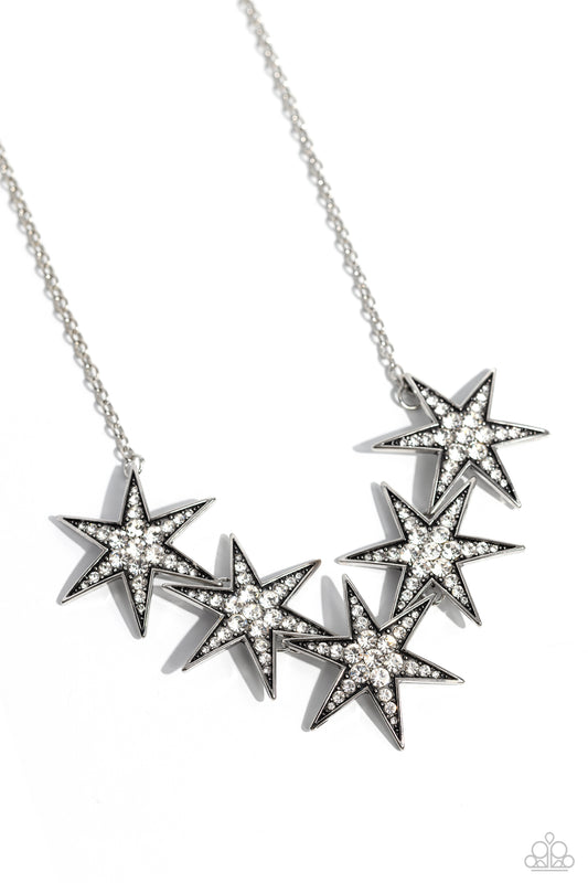 Paparazzi Accessories Rockstar Ready - White Dotted with various sizes of highly reflective white rhinestones, a stellar collection of 3D silver stars interlock from a dainty silver link chain for an out-of-this-world edgy fashion. Features an adjustable