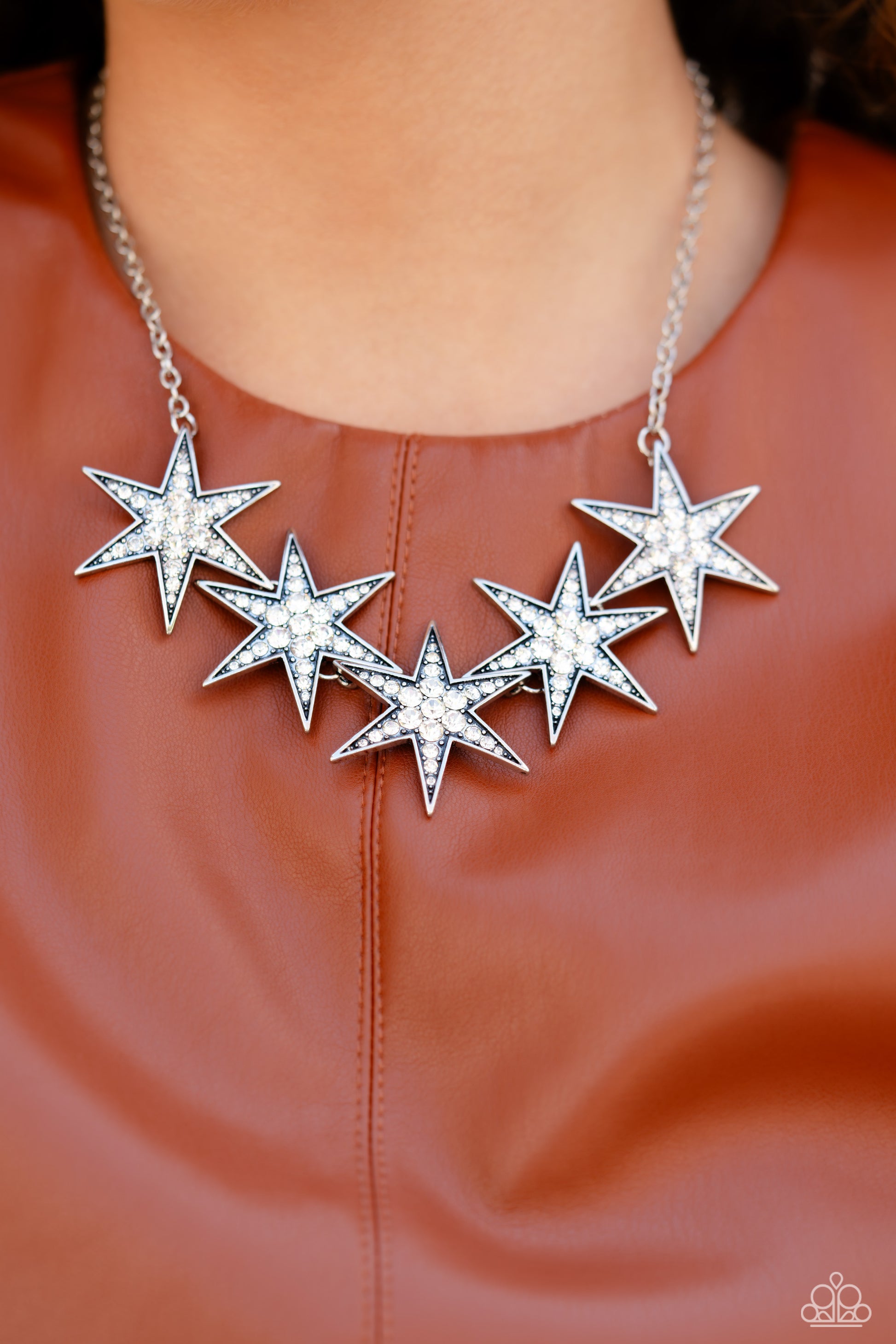 Paparazzi Accessories Rockstar Ready - White Dotted with various sizes of highly reflective white rhinestones, a stellar collection of 3D silver stars interlock from a dainty silver link chain for an out-of-this-world edgy fashion. Features an adjustable