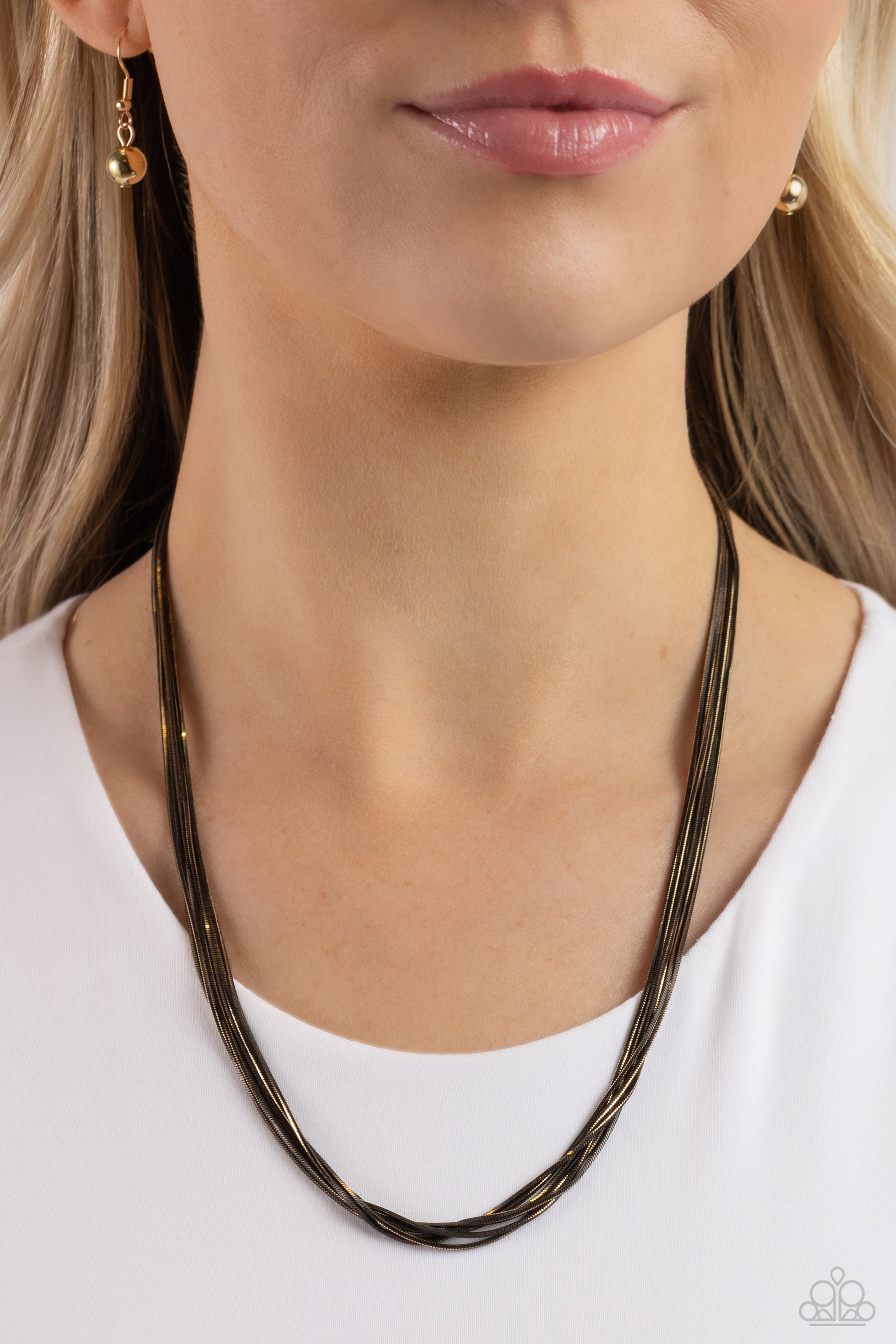 Paparazzi Accessories Salvaging Sass - Black Featuring shiny gold and glistening gunmetal links, six strands of slim snake chains drape across the chest for an edgy mixed metallic finish. Features an adjustable clasp closure. Sold as one individual neckla
