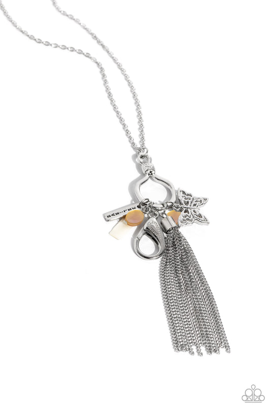 Paparazzi Accessories SHELL-ebrity Showcase - White Accented with white and brown shell accents, a silver tassel, an ornate silver butterfly, and a silver bar with the word "believe" stamped on it cascade from the bottom of an elongated silver hoop with a