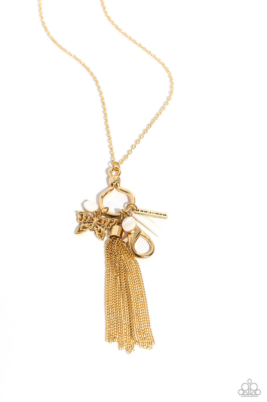 Paparazzi Accessories SHELL-ebrity Showcase - Gold Accented with white shell accents, a gold tassel, an ornate gold butterfly, and a gold bar with the word "believe" stamped on it cascade from the bottom of an elongated gold hoop with a hammered accent an