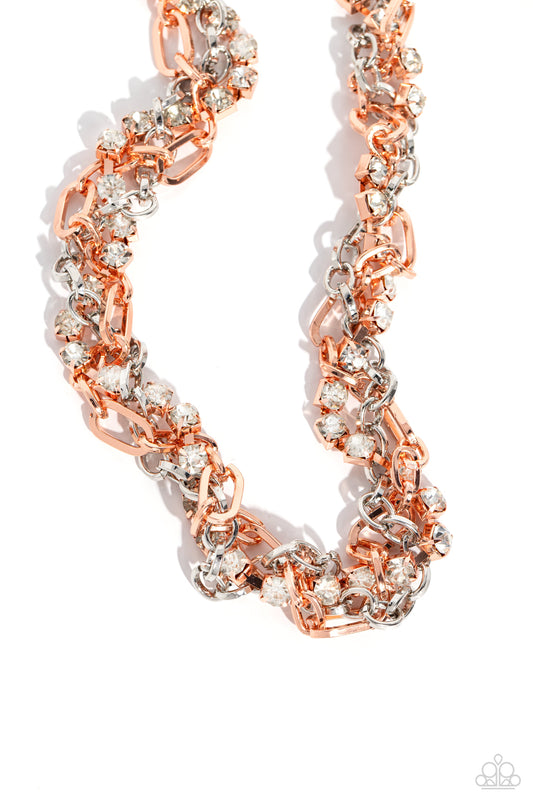 Paparazzi Accessories Totally Two-Toned - Copper Mismatched strands of glistening shiny copper and silver oval links are intertwined with a row of sparkling, square-cut, white rhinestones encased in sleek shiny copper fittings, resulting in a twisted coll