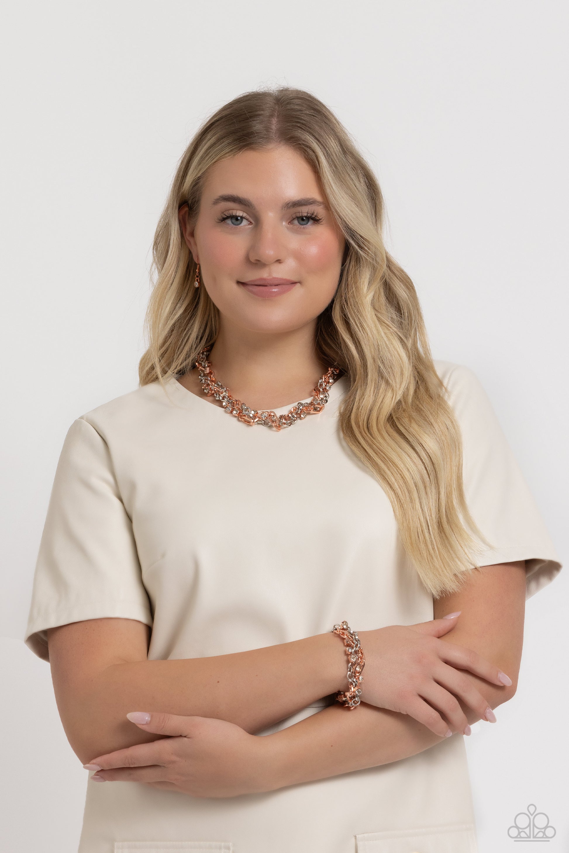 Paparazzi Accessories Totally Two-Toned - Copper Mismatched strands of glistening shiny copper and silver oval links are intertwined with a row of sparkling, square-cut, white rhinestones encased in sleek shiny copper fittings, resulting in a twisted coll