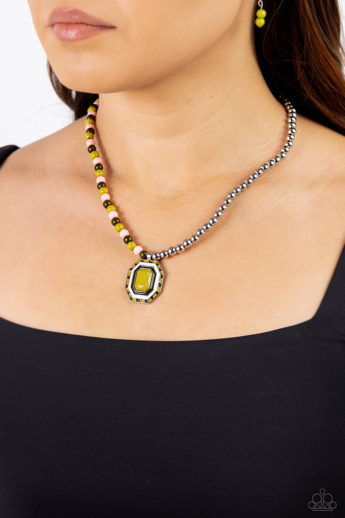 Paparazzi Accessories Contrasting Candy - Green A strand of silver beads collides with Leek Green, Crystal Rose, and olive glossy beads that lay on the opposite side to create a contrasting blend of color and sheen. An oversized emerald-cut pendant featur