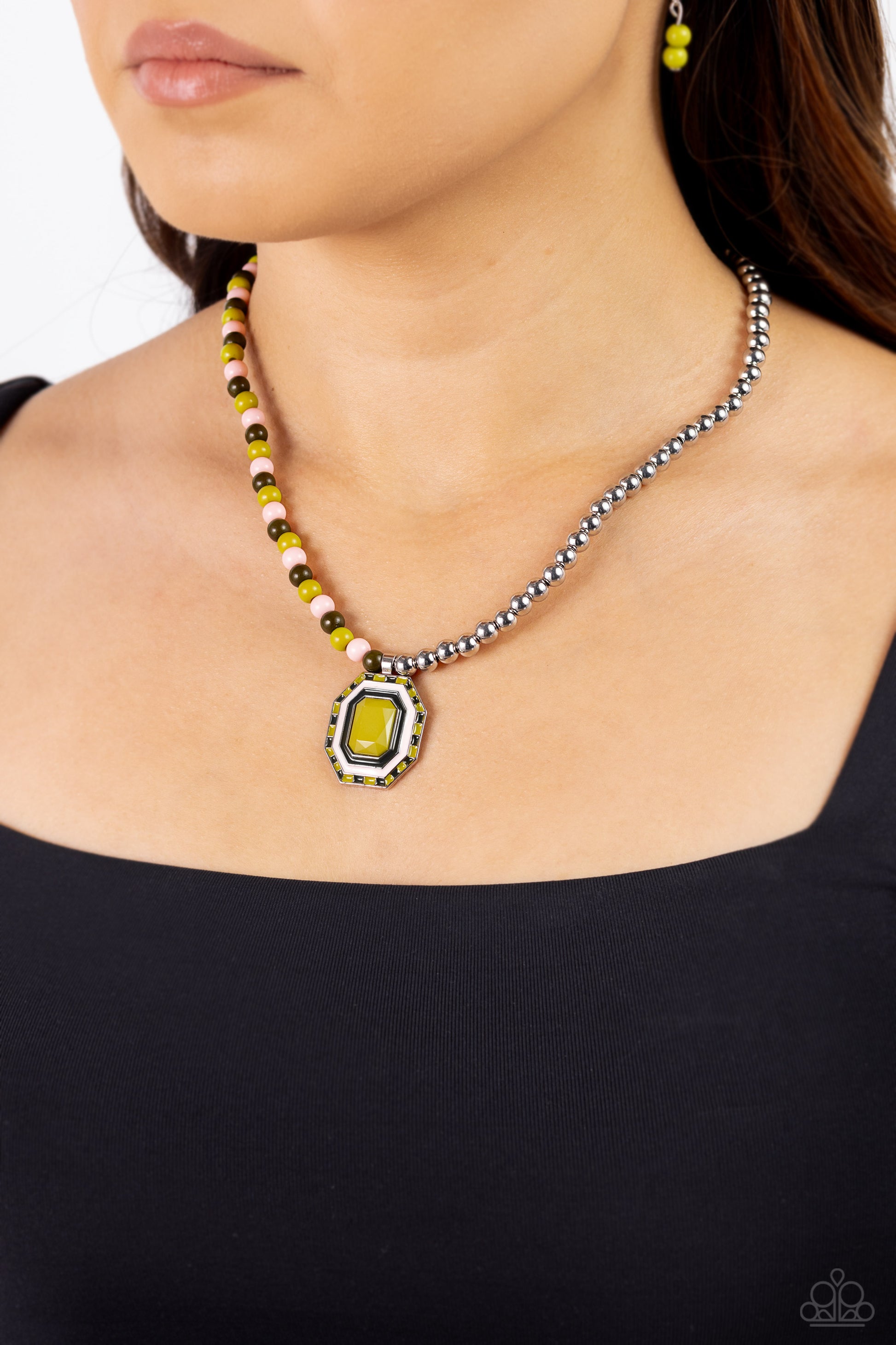 Paparazzi Accessories Contrasting Candy - Green A strand of silver beads collides with Leek Green, Crystal Rose, and olive glossy beads that lay on the opposite side to create a contrasting blend of color and sheen. An oversized emerald-cut pendant featur