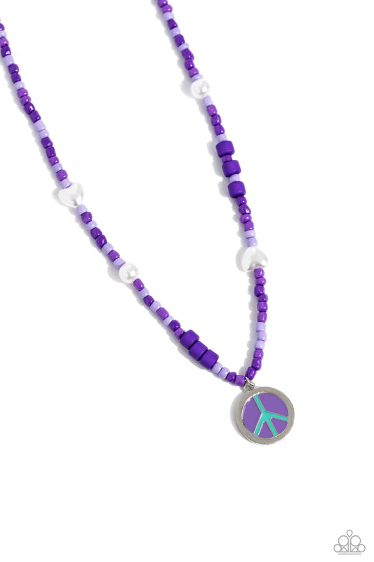 Paparazzi Accessories Pearly Possession - Purple Infused along an invisible string, lavender, plum, and purple seed beads combine with sporadically placed purple discs, and glossy white and heart-shaped pearls for a vibrant pop of color along the neckline