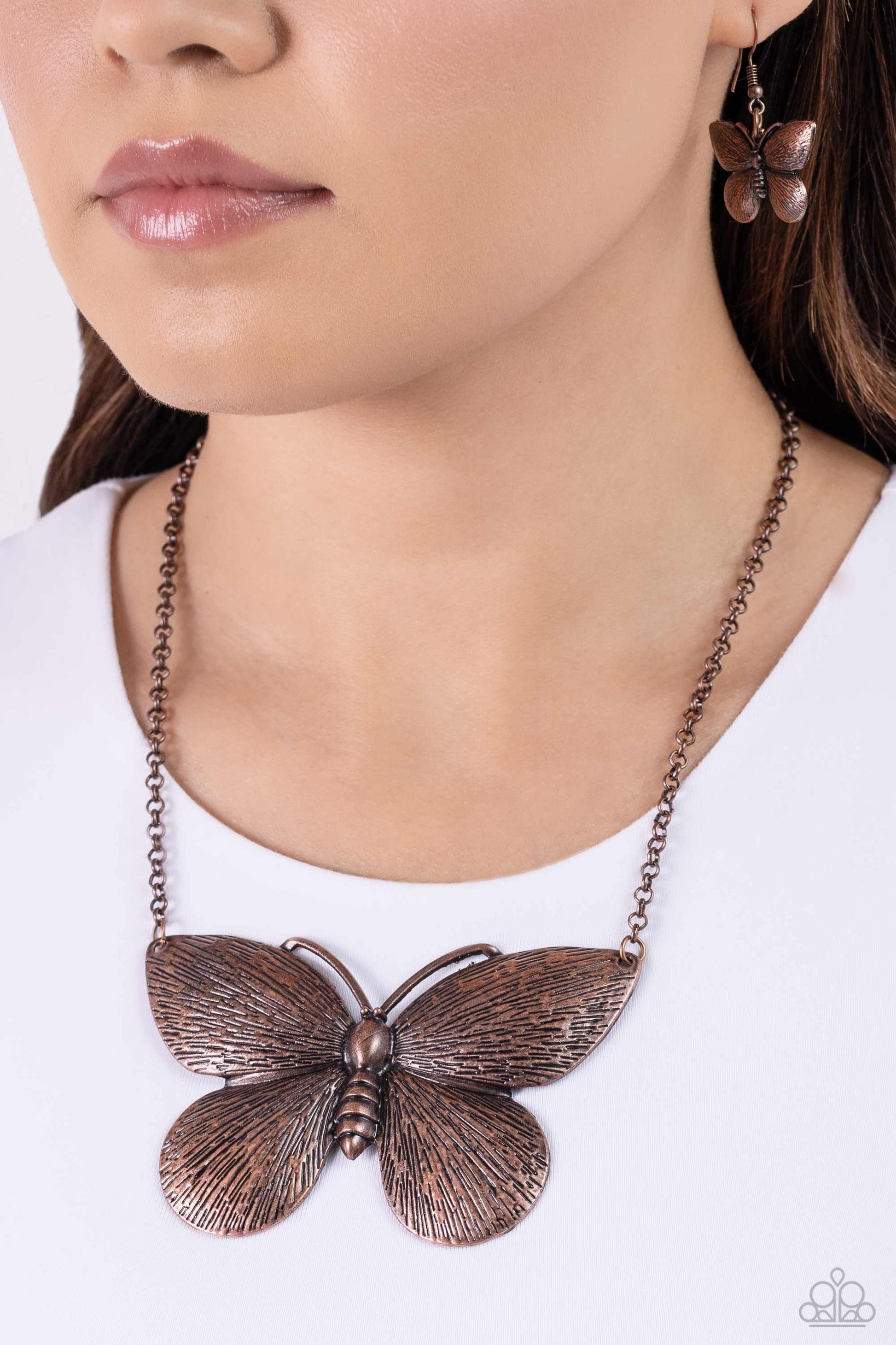 Paparazzi Accessories DRAWN to the Wind - Copper Brushed in a linear texture, an exaggeratedly large copper moth plate flutters along a copper chain below the collar for an enchanting fashion. Features an adjustable clasp closure. Sold as one individual n