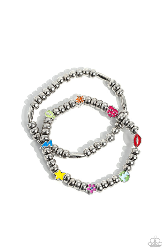 Paparazzi Accessories Charming Campaign - Multi A strand of textured, cylindrical, and round high-sheen silver beads combine with a single strand of silver beads, sporadically infused with vivacious charm beads to create an energetic stack of stretchy bra