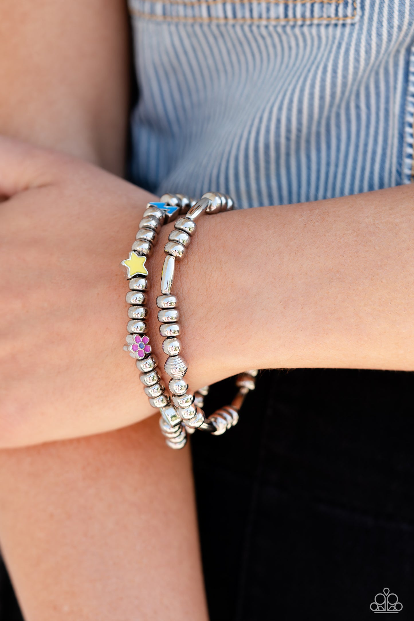 Paparazzi Accessories Charming Campaign - Multi A strand of textured, cylindrical, and round high-sheen silver beads combine with a single strand of silver beads, sporadically infused with vivacious charm beads to create an energetic stack of stretchy bra