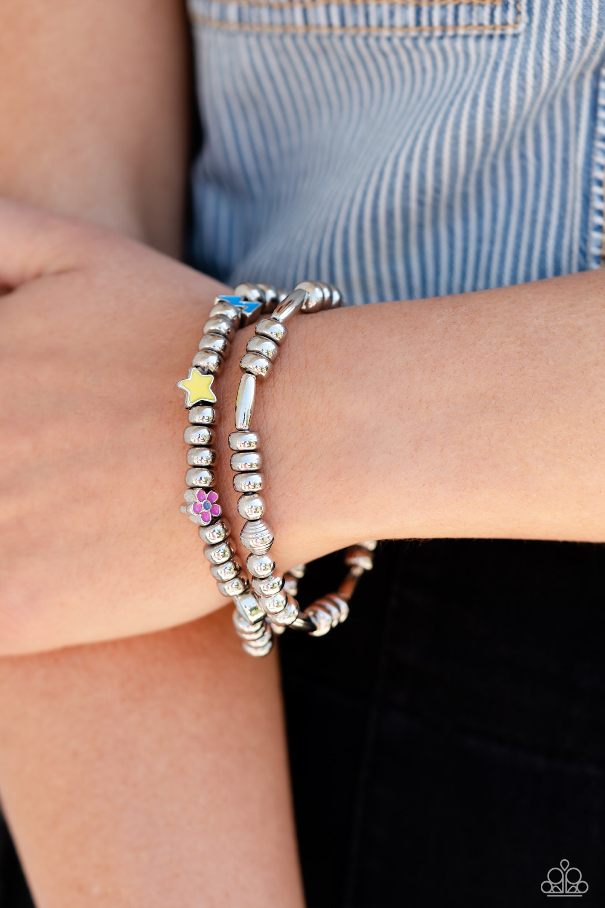 Paparazzi Accessories Charming Campaign - Multi A strand of textured, cylindrical, and round high-sheen silver beads combine with a single strand of silver beads, sporadically infused with vivacious charm beads to create an energetic stack of stretchy bra