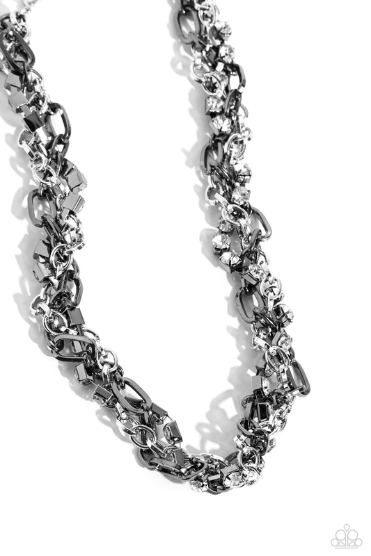 Paparazzi Accessories Totally Two-Toned - Silver Mismatched strands of glistening shiny gunmetal and silver oval links are intertwined with a row of sparkling, square-cut, white rhinestones encased in sleek shiny silver fittings, resulting in a twisted co