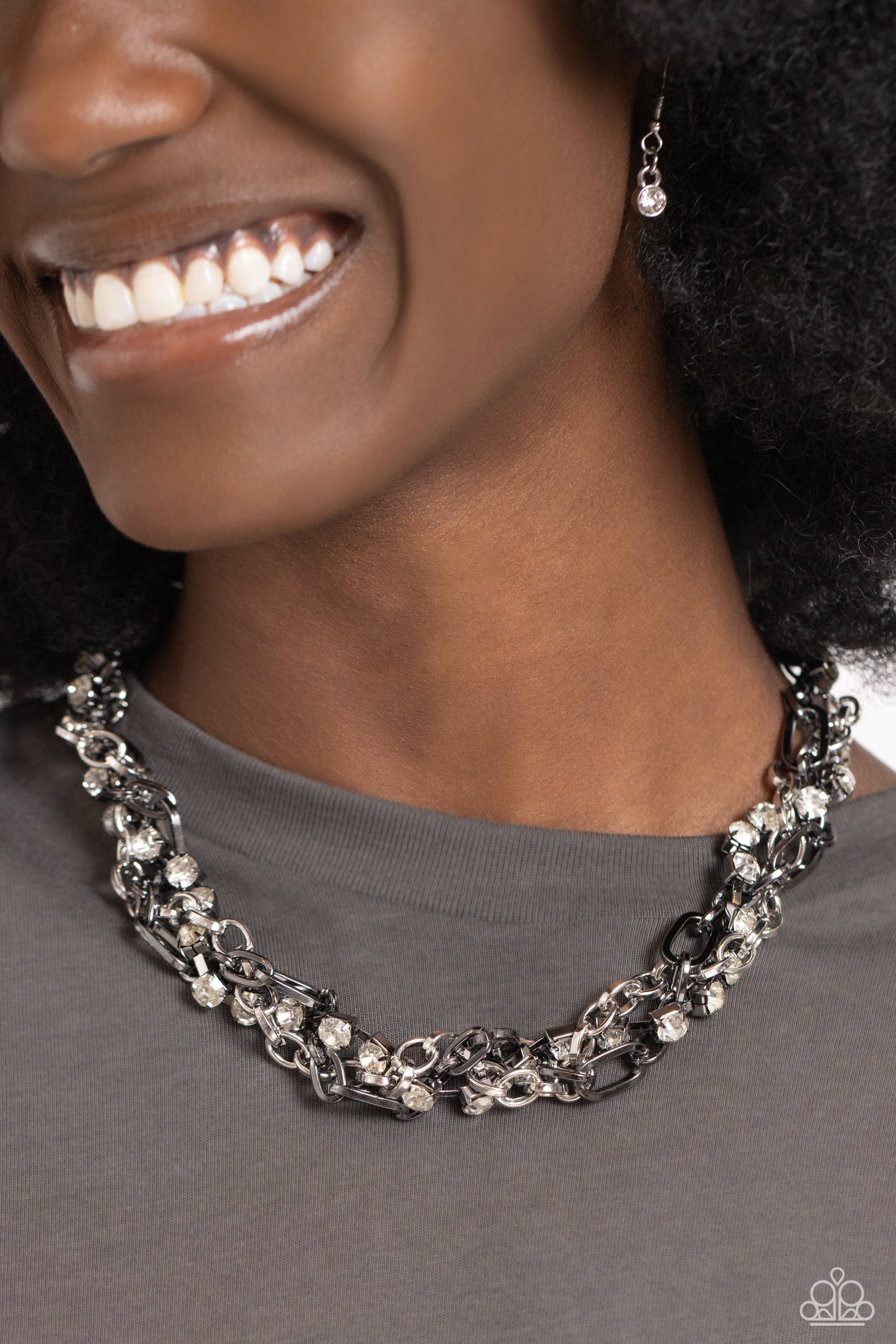 Paparazzi Accessories Totally Two-Toned - Silver Mismatched strands of glistening shiny gunmetal and silver oval links are intertwined with a row of sparkling, square-cut, white rhinestones encased in sleek shiny silver fittings, resulting in a twisted co
