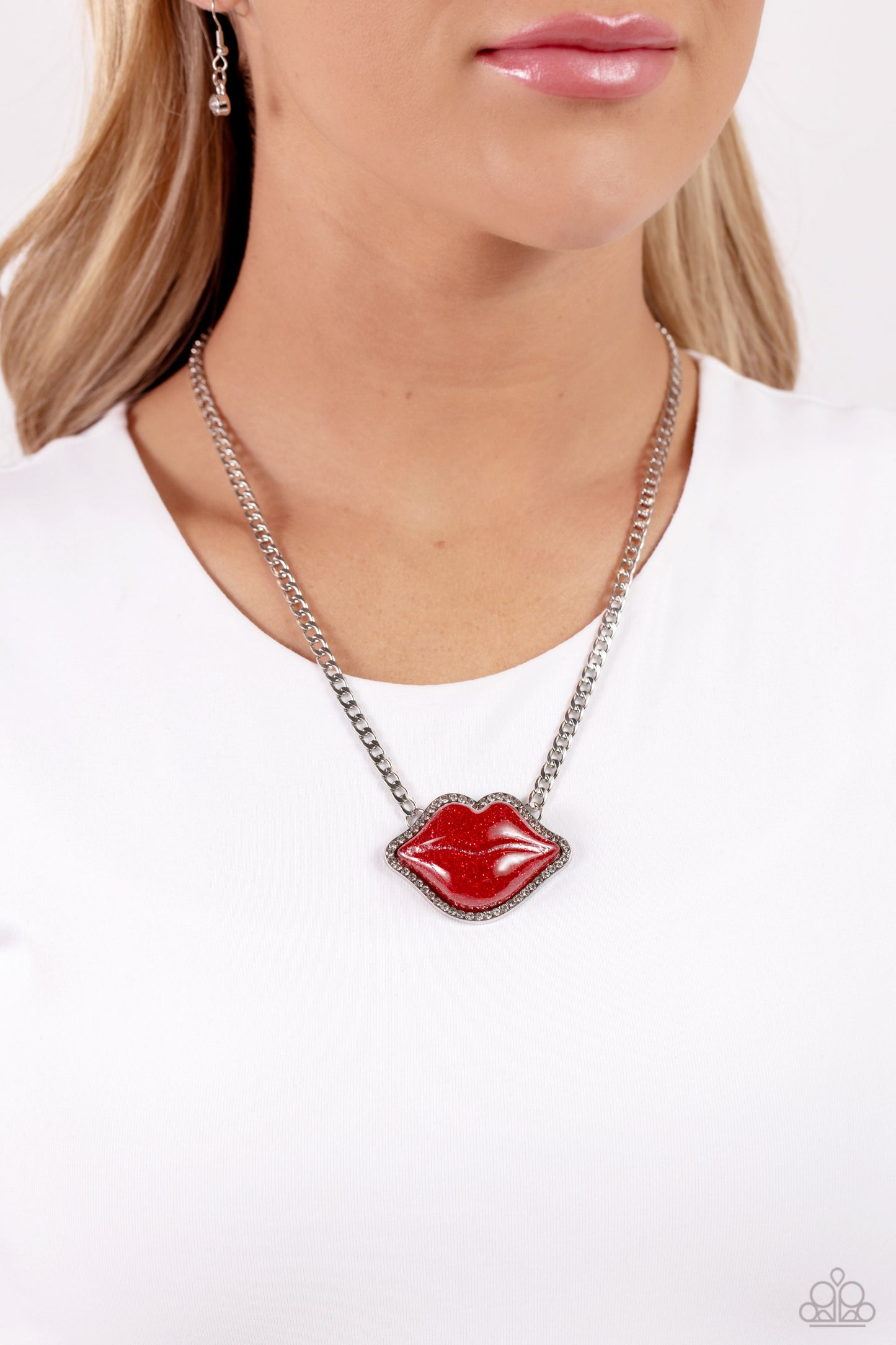 Paparazzi Accessories Lip Locked - Red Featuring a glittery finish, an oversized red lip pendant swings from the bottom of a silver link chain below the collar for a romantic statement. White rhinestones border the charm for additional stunning detail. Fe