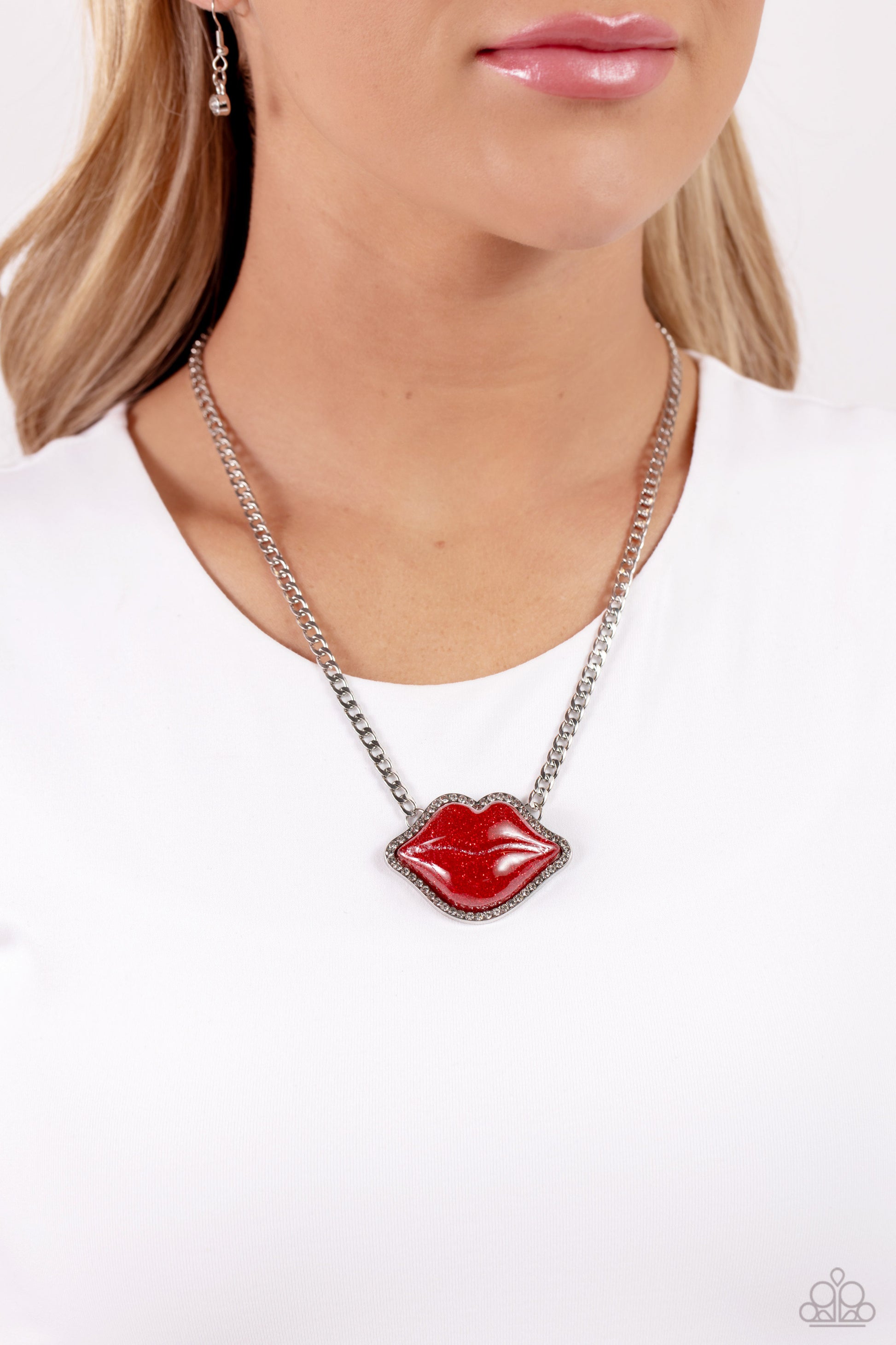 Paparazzi Accessories Lip Locked - Red Featuring a glittery finish, an oversized red lip pendant swings from the bottom of a silver link chain below the collar for a romantic statement. White rhinestones border the charm for additional stunning detail. Fe