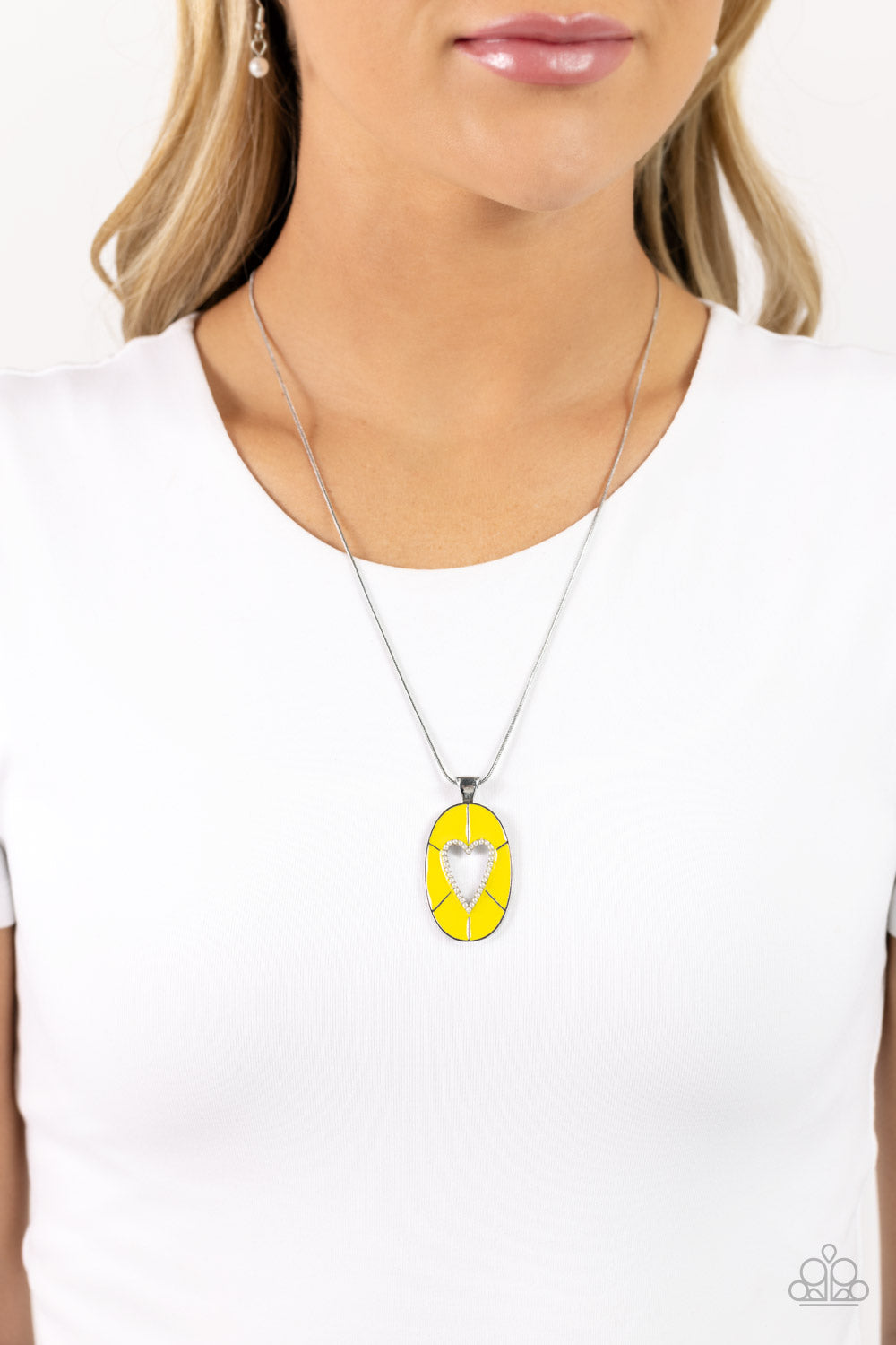 Paparazzi Accessories Airy Affection - Yellow Featuring High Visibility paint, a silver oval pendant with an airy heart silhouette swings from the bottom of a silver snake chain. Dainty white pearls dust along the heart's border for a refined flair. Featu