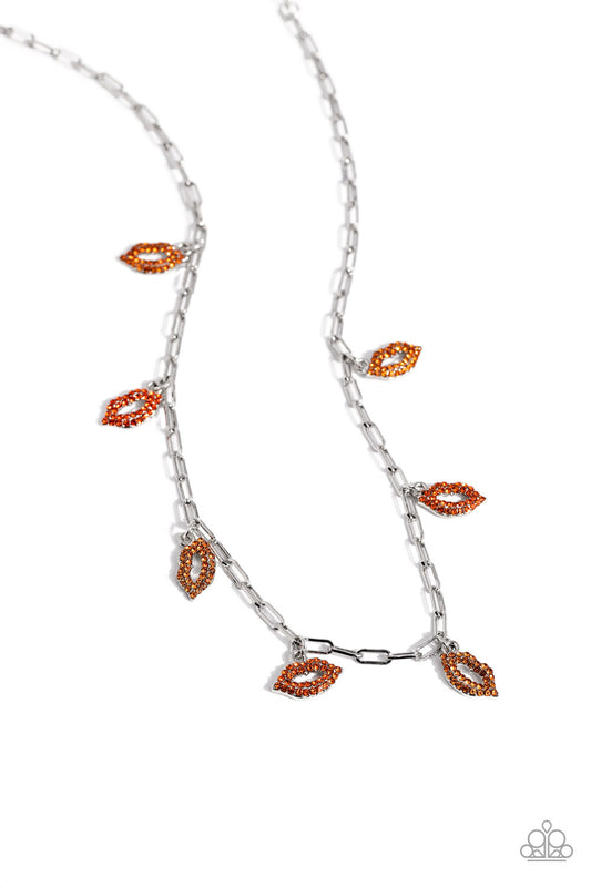 Paparazzi Accessories KISS the Mark - Orange Gliding along a silver paperclip chain, a pouty collection of lip charms, each embossed in various shades of orange rhinestones, alternates below the collar for a love-struck fashion. Features an adjustable cla