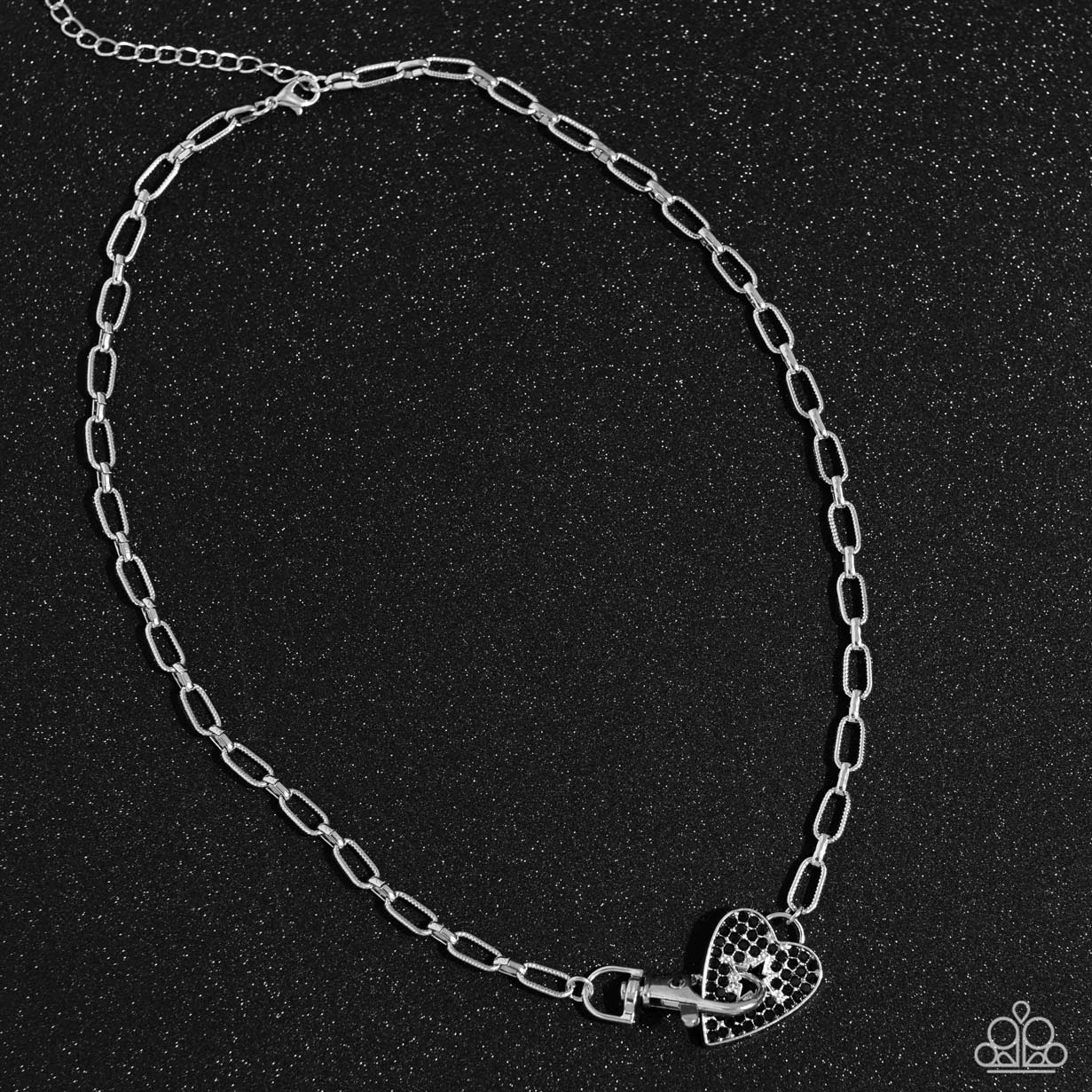 Paparazzi Accessories Radical Romance - Black Featuring a subtly studded finish, a silver paperclip chain leads the eye down to a black rhinestone-encrusted heart. A black rhinestone-embellished lobster clasp connects to the center of the heart display fo