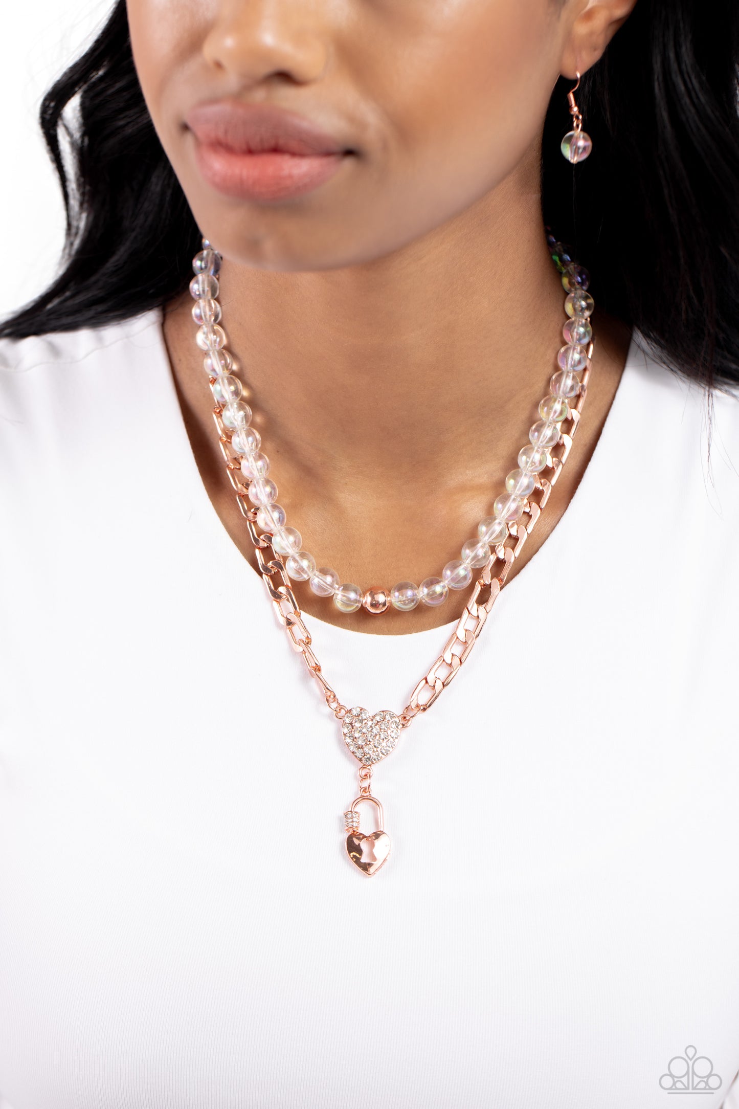 Paparazzi Accessories Turn Back the LOCK - Copper Layered atop a bold shiny copper elongated curb chain, a strand of clear beads featuring an iridescent shimmer is threaded along an invisible wire below the collar, resulting in a colorfully layered design