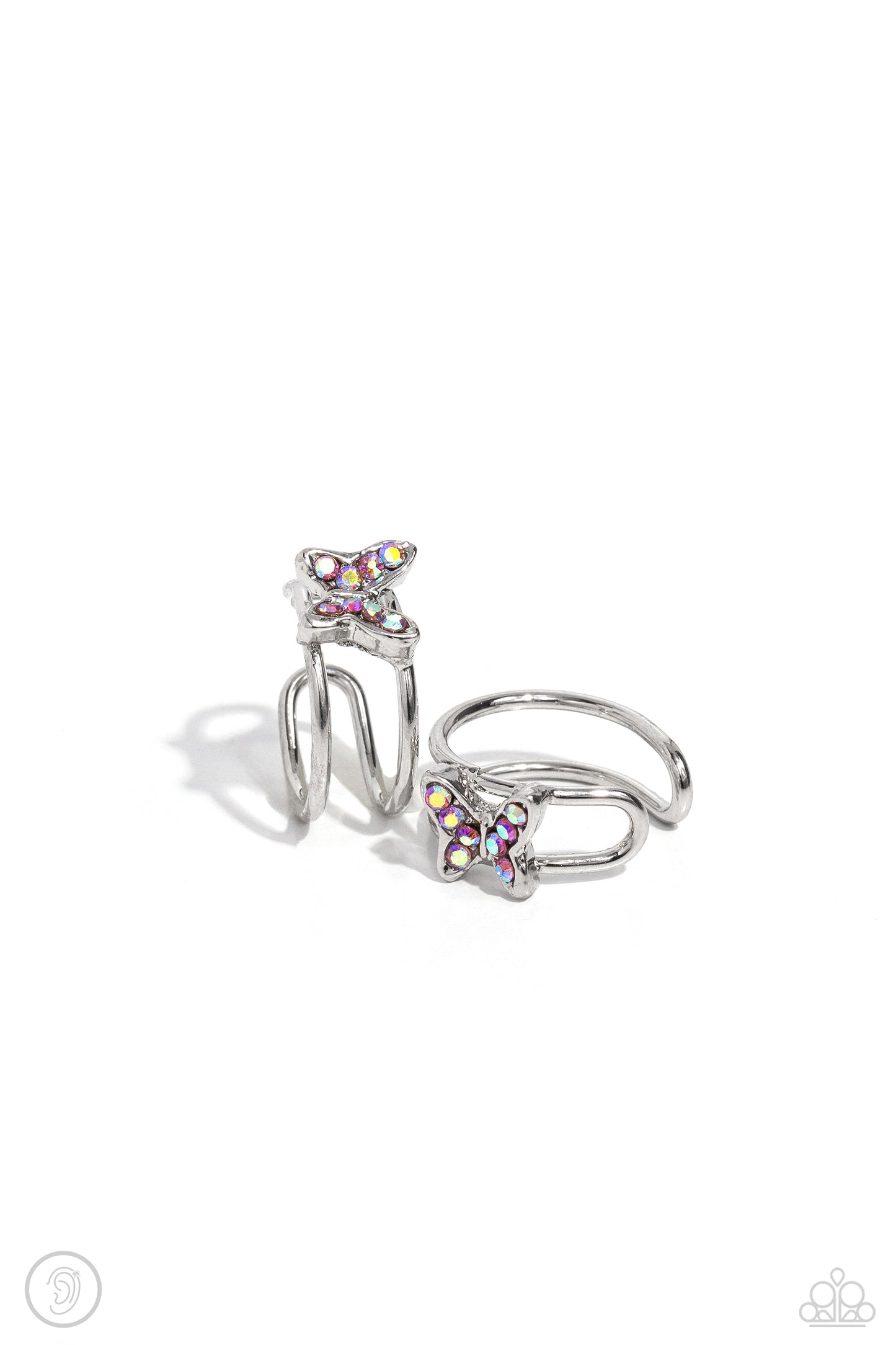 Paparazzi Accessories Soaring Sideways - Pink Fluttering atop an airy silver fitting, a pink iridescent-encrusted silver butterfly shines from the ear. Features a smooth surface for sliding ability to desired position on the ear. Due to its structure, adj