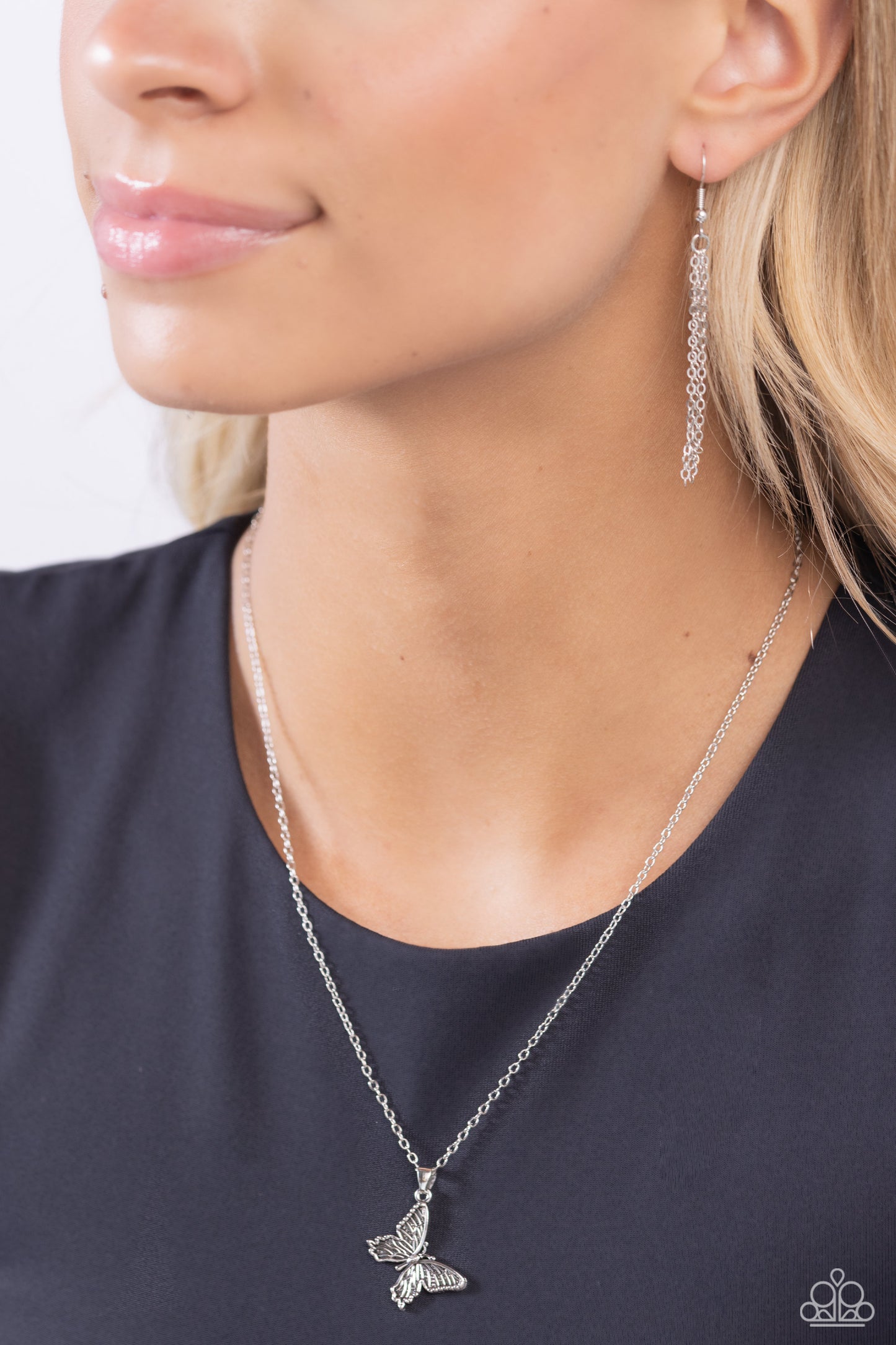 Paparazzi Accessories Midair Magic - Silver Featuring linear textures, a tilted silver butterfly flutters down the neckline from a dainty silver chain for a whimsical centerpiece. Features an adjustable clasp closure. Sold as one individual necklace. Incl