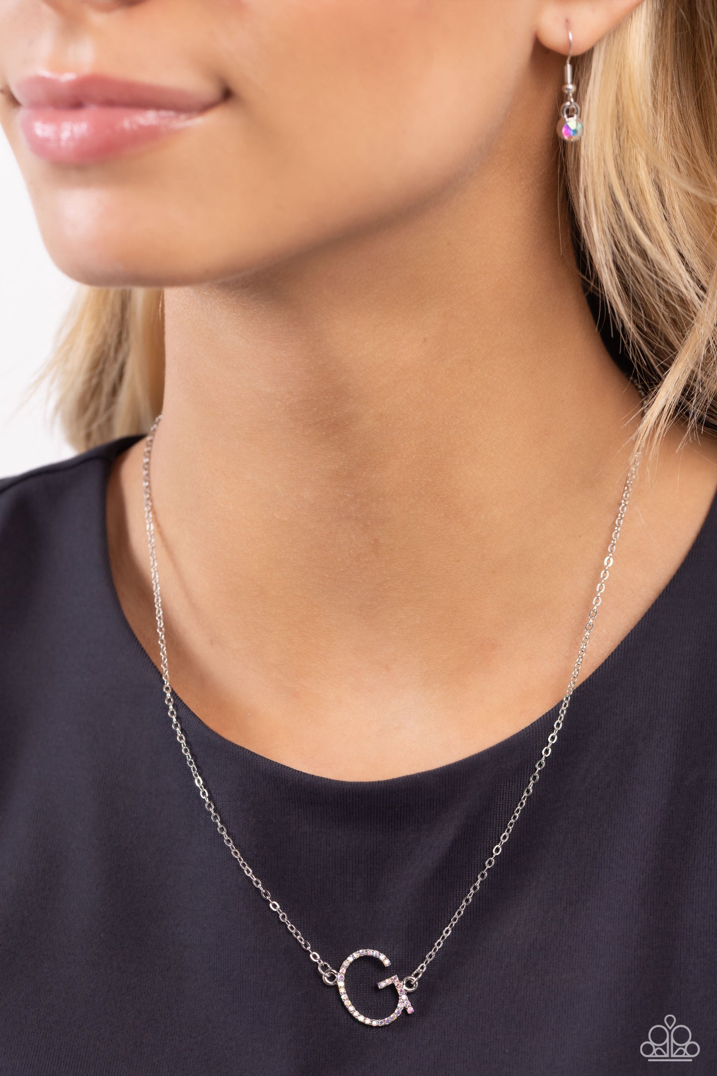 Paparazzi Accessories INITIALLY Yours - G - Multi Embossed with dainty iridescent rhinestones, a silver letter "G" hovers below the collar from a dainty silver chain, for a sentimentally simple design. Features an adjustable clasp closure. Due to its pris