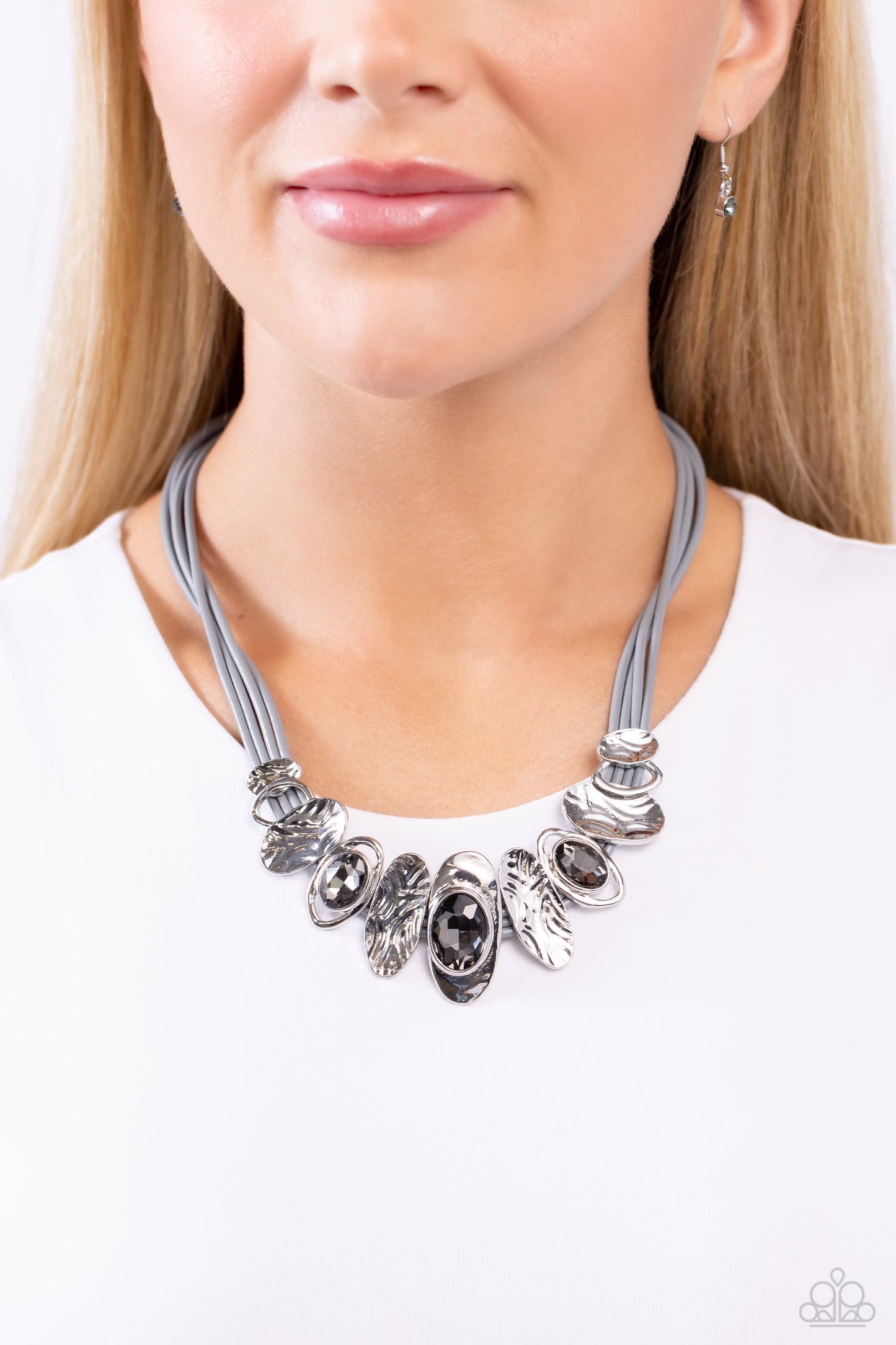 Paparazzi Accessories Sliding Splendor - Silver Featuring a lightly hammered sheen, asymmetrical silver ovals, some with airy silhouettes and exaggerated smoky gem centers, give off a hand-made feel as they shift and slide through multiple strands of gray