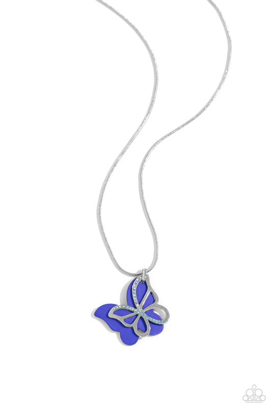 Paparazzi Accessories Detailed Dance - Blue Layered beside a silver butterfly silhouette dotted with aquamarine and blue-iridescent rhinestones, a royal blue-painted acrylic butterfly flutters from a silver snake chain below the collar for a whimsical fas