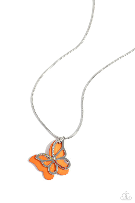 Paparazzi Accessories Detailed Dance - Orange Layered beside a silver butterfly silhouette dotted with light peach, orange, and peachy-iridescent rhinestones, an orange-painted acrylic butterfly flutters from a silver snake chain below the collar for a wh
